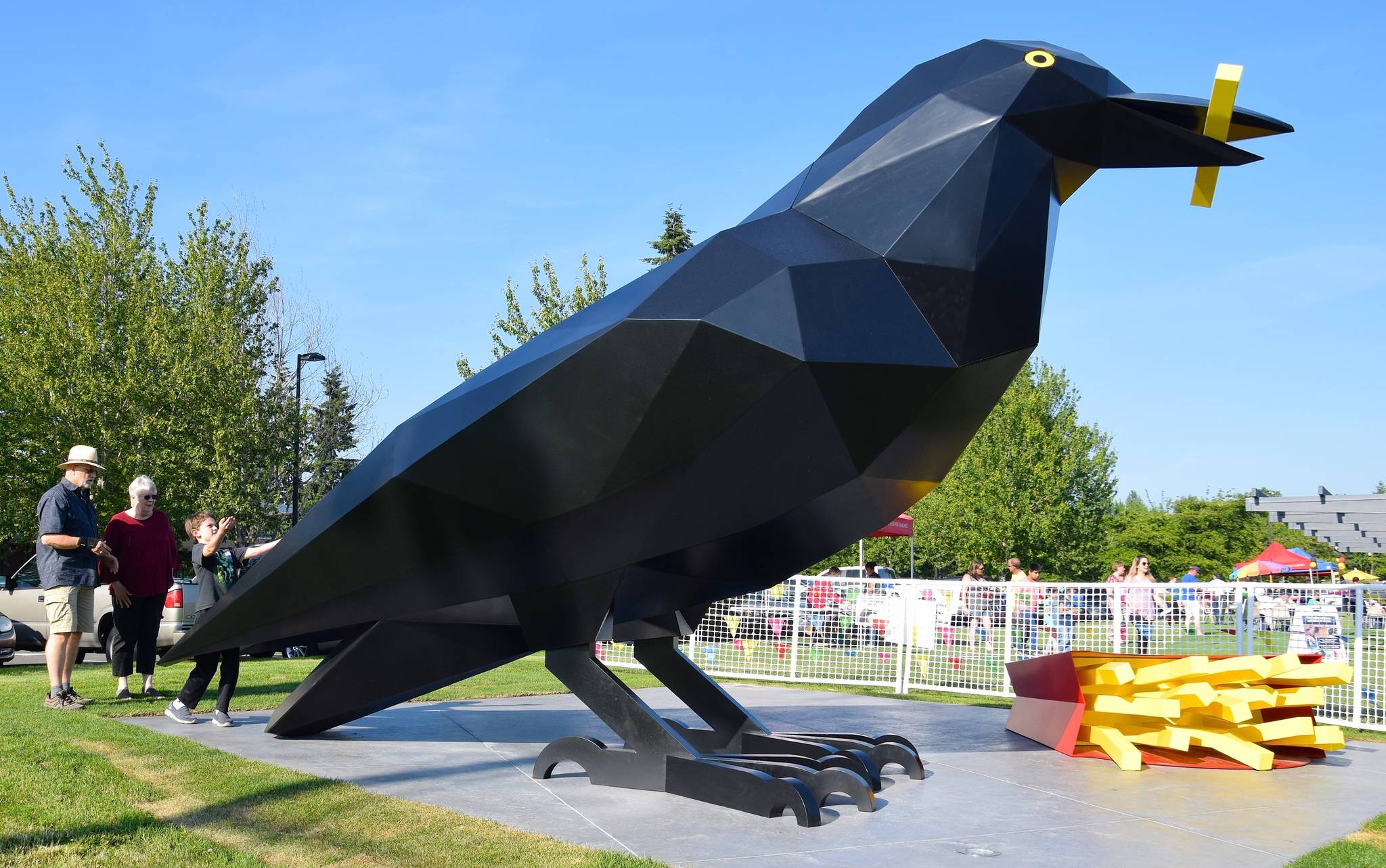 John and Kris Rogers and Matthew Selvar, 9, observe the crow, a new inhabitant at Les Gove Park. RACHEL CIAMPI, Auburn Reporter