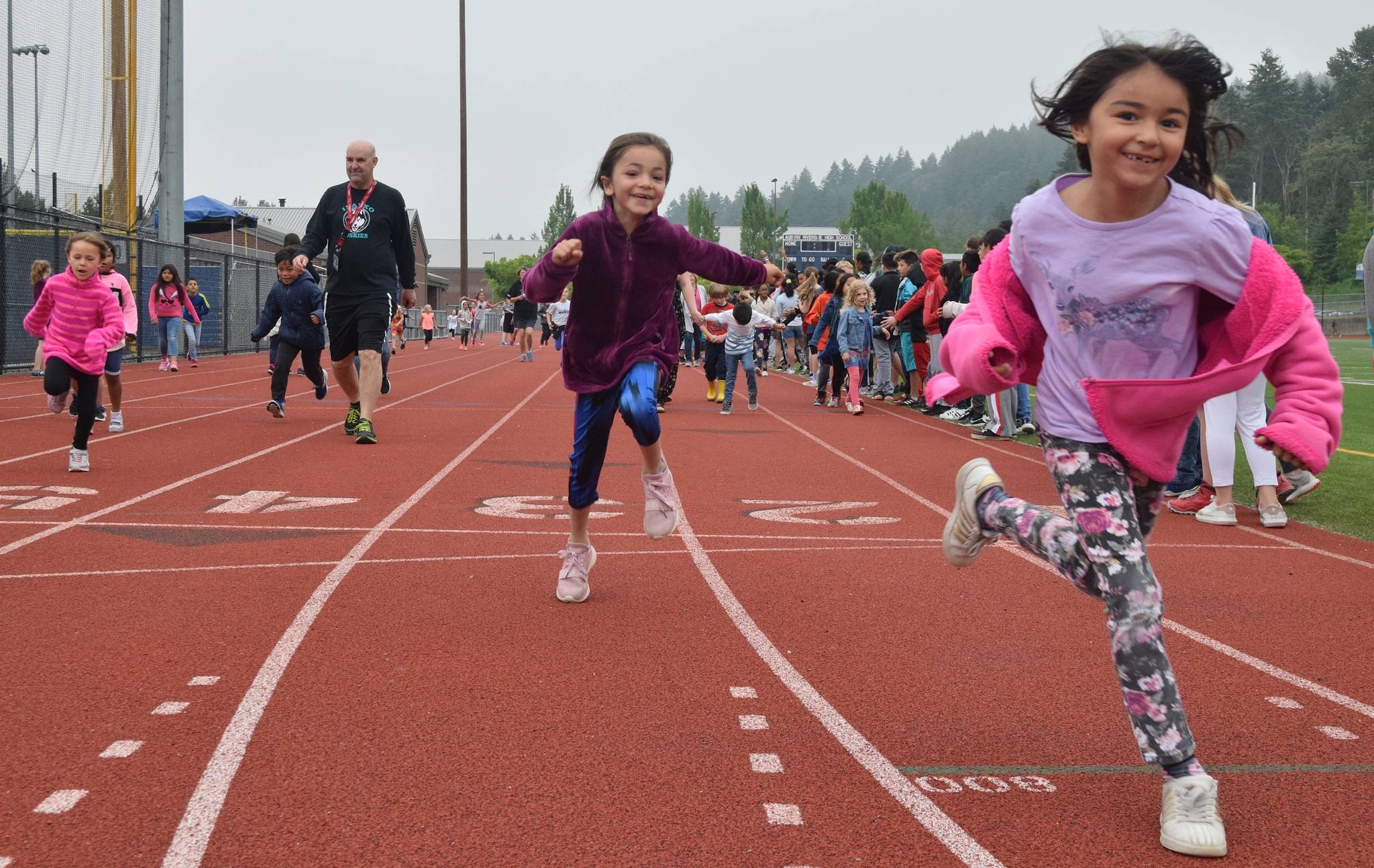 Illako Elementary School Assistant Principal James House joins students for the traditional Mile Run on the Auburn Riverside High School oval last Friday. RACHEL CIAMPI, Auburn Reporter