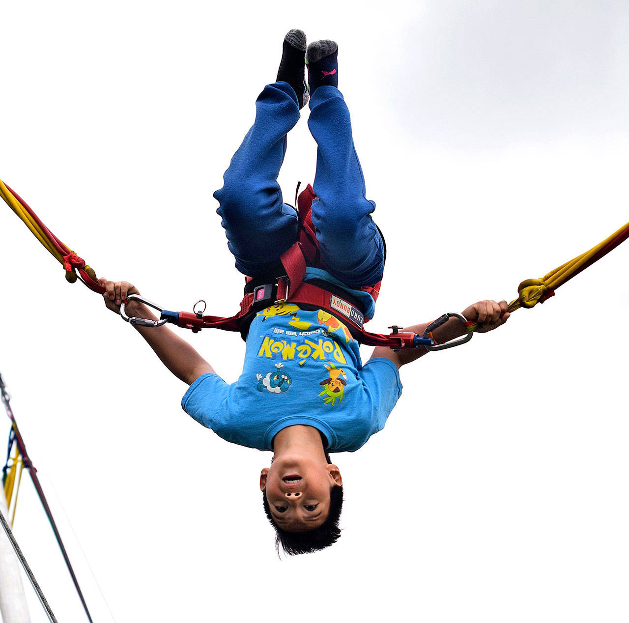 Christian Cordova does a flip on the bungee trampoline at KidsDay last year. RACHEL CIAMPI, Auburn Reporter