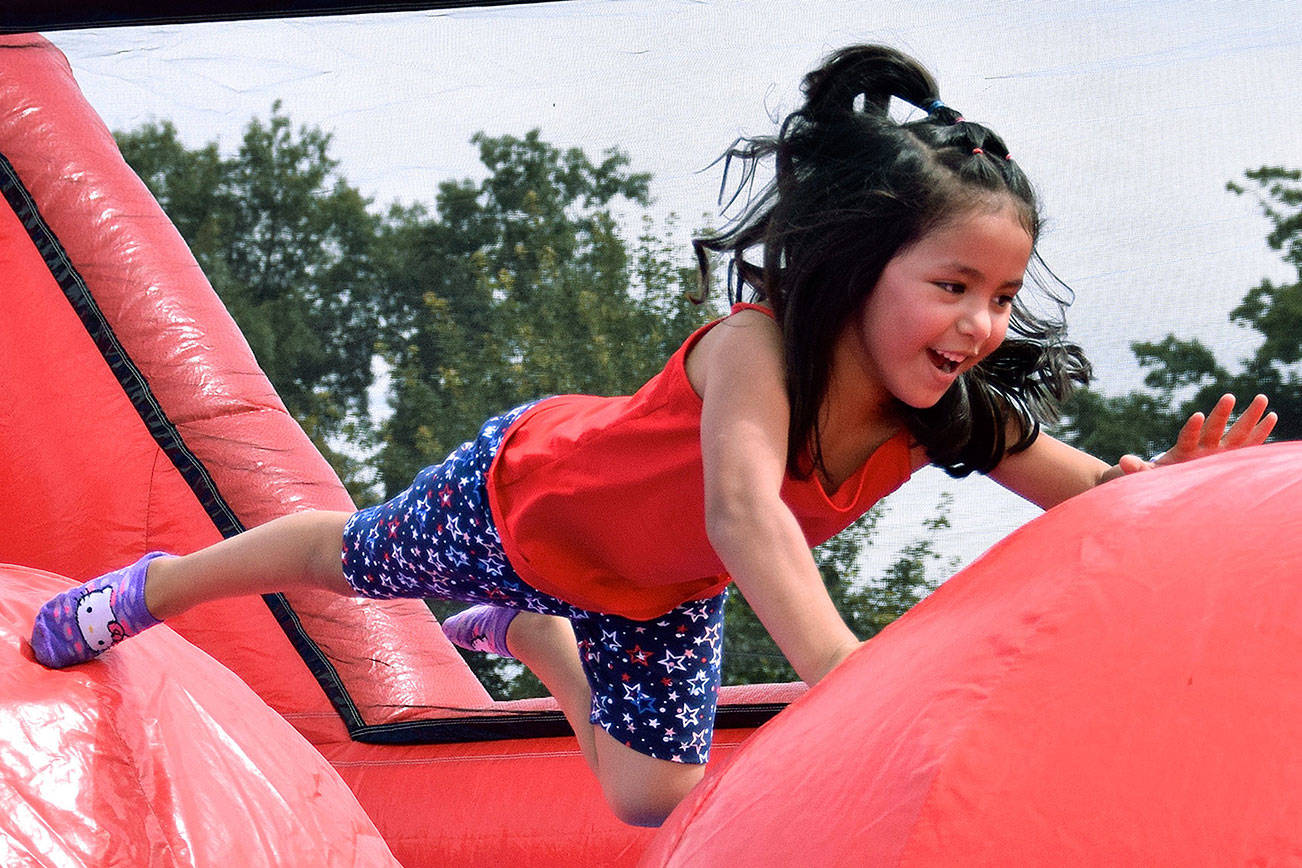 Valeria Del Razo Artadi jumps on the inflatable during the Fourth of July Festival last year to Les Gove Park. RACHEL CIAMPI, Auburn Reporter