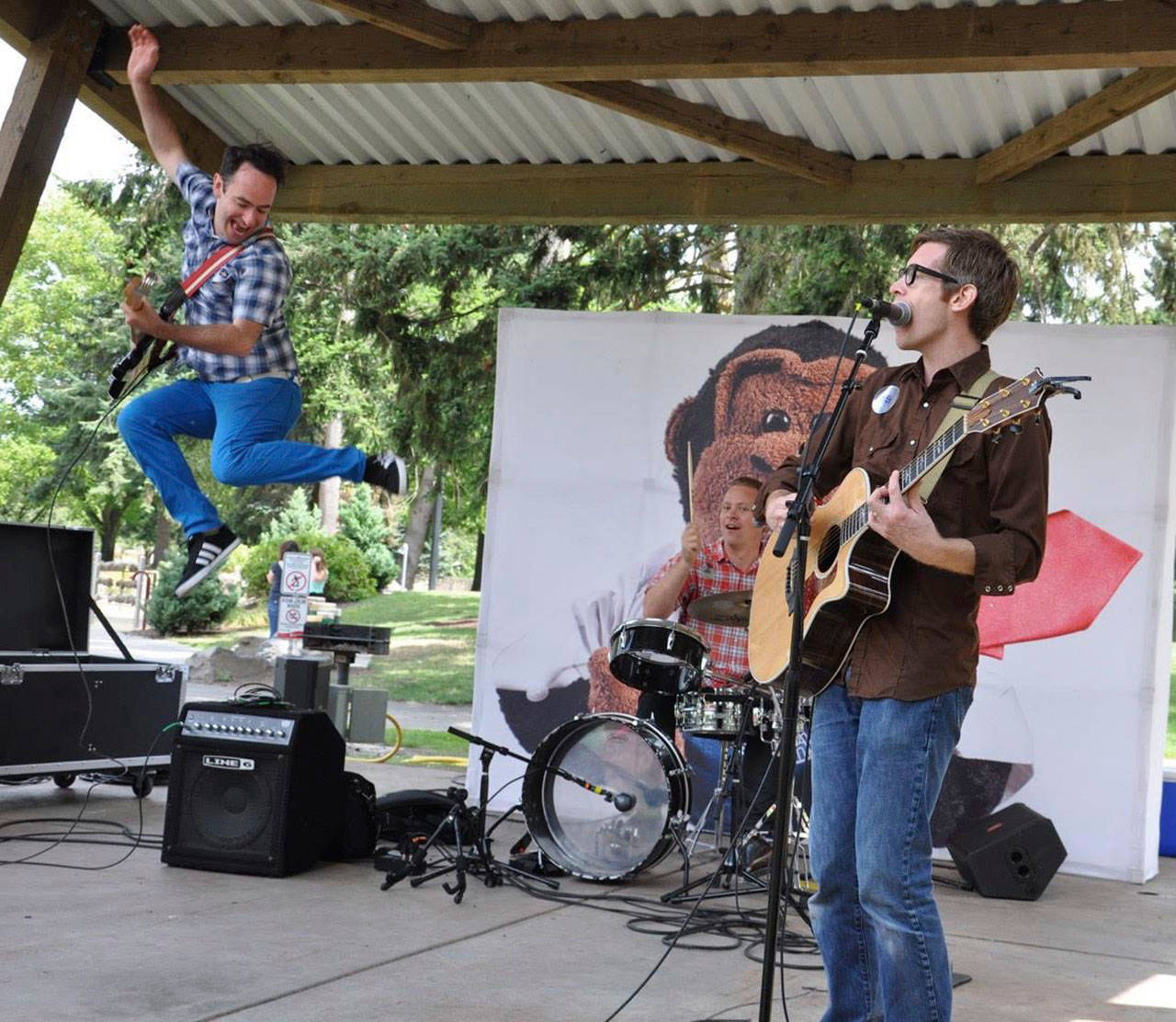 Jack Forman leaps as Korum Bischoff (on drums) and Drew Holloway jam during a recent Recess Monkey’s Kids Summerstage visit. The trio, an acclaimed family music band from Seattle, returns to Les Gove Park on July 24. RACHEL CIAMPI, Auburn Reporter