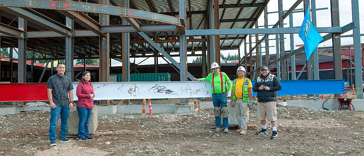 Jaison Elkins, Muckleshoot Tribal Council chair, far left; Jessica Garcia-Jones, Muckleshoot Tribal Council member, left; and Donny Stevenson, Muckleshoot Tribal Council vice-chair, far right, are joined by two tribal construction workers for the historic event. COURTESY PHOTO, Muckleshoot Tribe