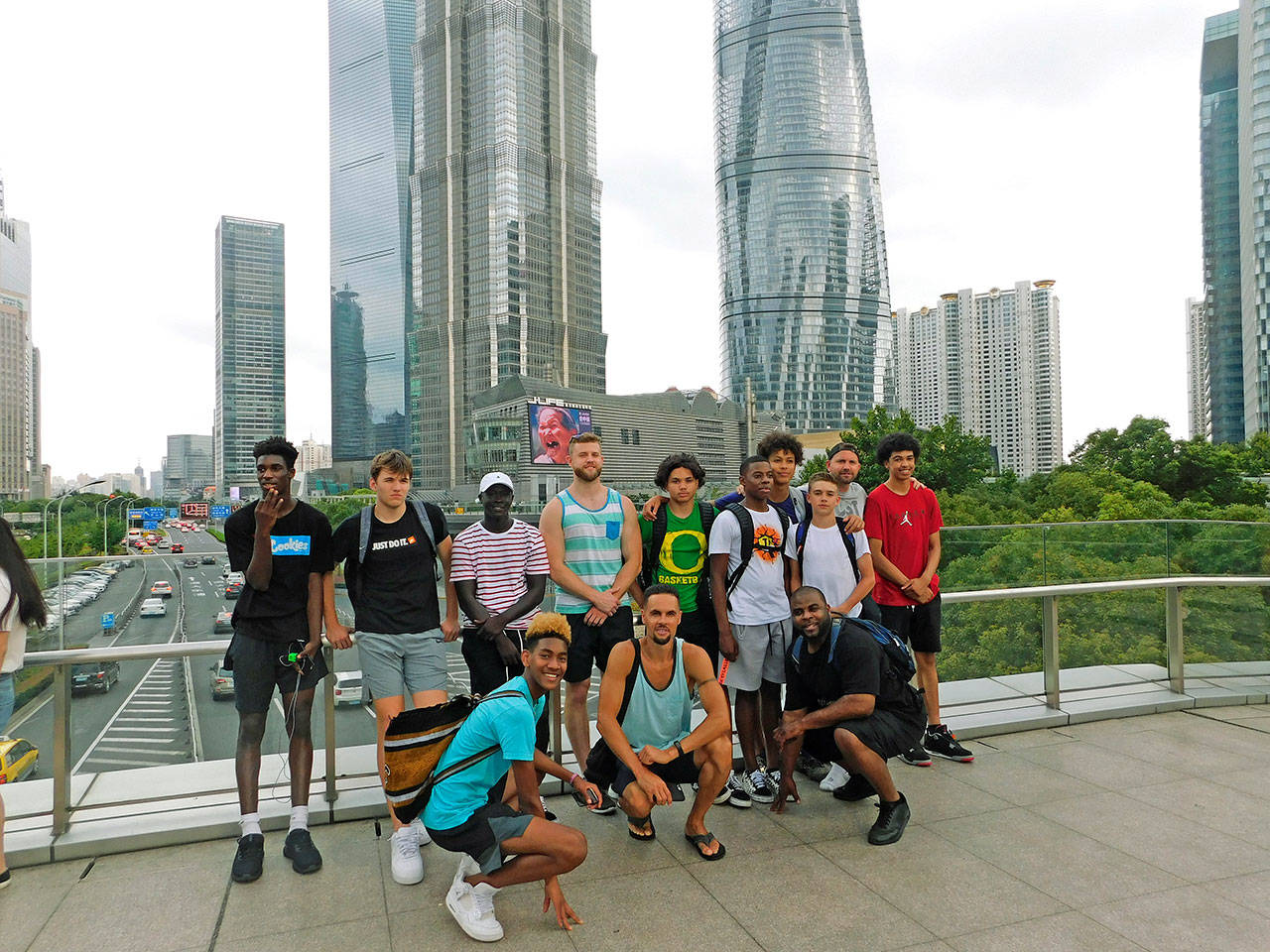 Auburn and local high school basketball players pose in front of downtown Shanghai during their 10-day visit to China. COURTESY PHOTO