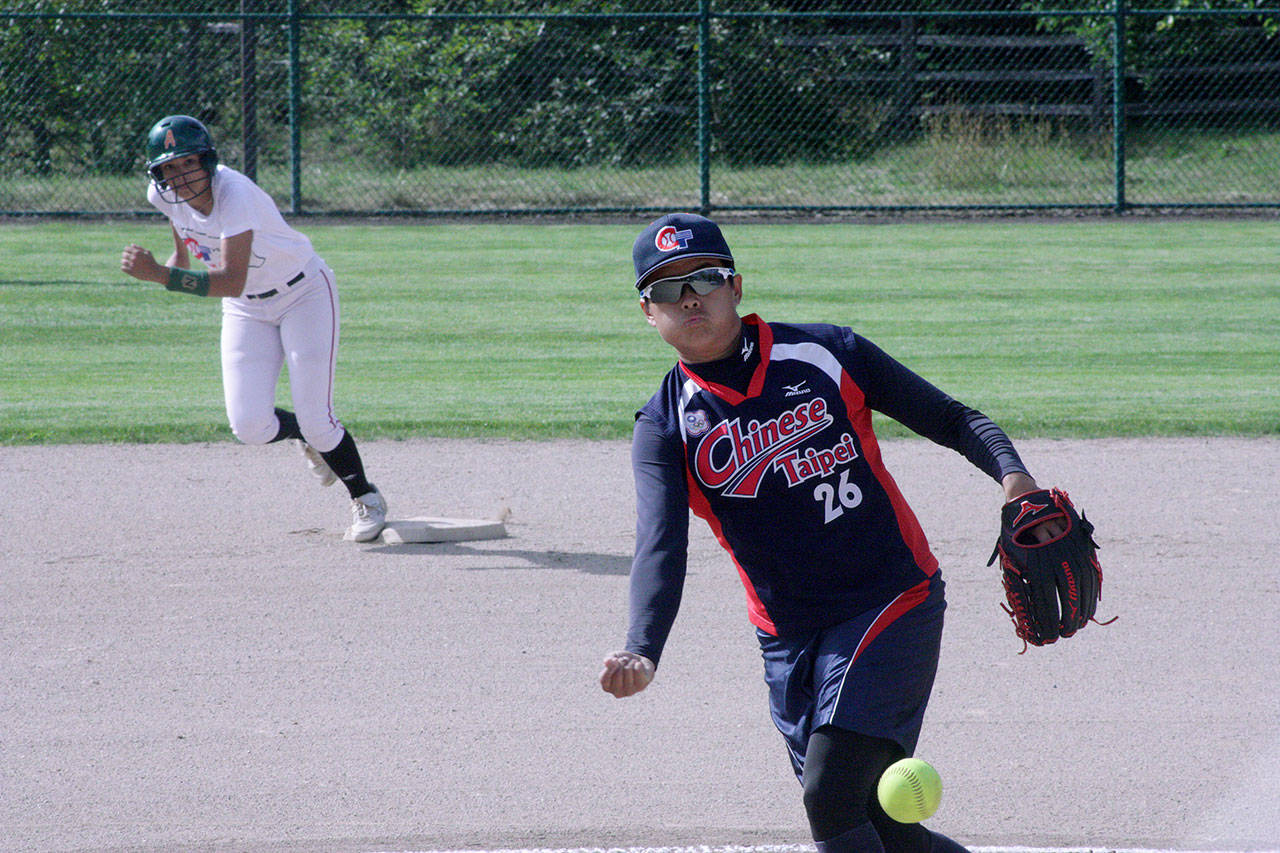 Chiu An-Ju, of the Chinese Taipei Olympic women’s team, delivers a pitch as Acer alum Destiny Conerly prepares to advance from second base during their exhibition softball game at the Service Club Community Park Ballfields in Kent on July 18. Conerly led off the first inning with a double but was left stranded. MARK KLAAS, Kent Reporter