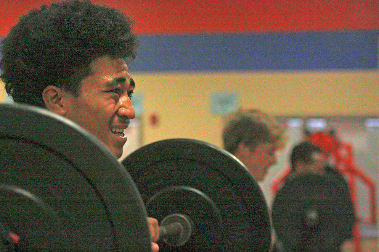 Keanu Mailoto, a 6-foot-3, 210-pound junior defensive end, and teammates pull and press weight during workouts Wednesday at Auburn Mountainview High School. MARK KLAAS, Auburn Reporter