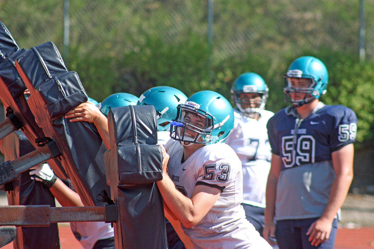 Auburn Riverside linemen push and lift the sled during summer camp drills Tuesday. MARK KLAAS, Auburn Reporter