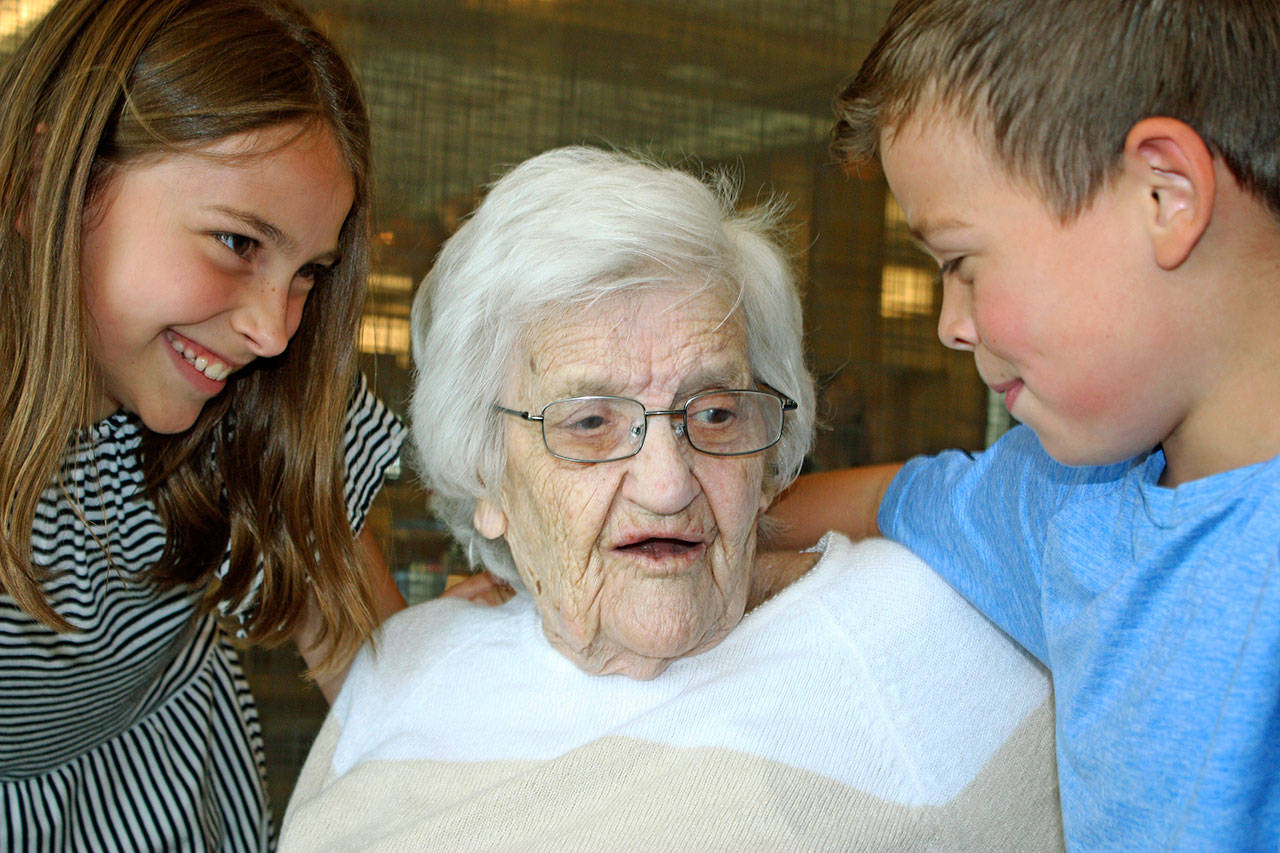Ruth Leslie shares a moment with great-grandchildren Justine Tilley, 11, left, and Oliver Tilley, 8, during her 102nd birthday party Sunday at Merrill Gardens in Auburn. MARK KLAAS, Auburn Reporter