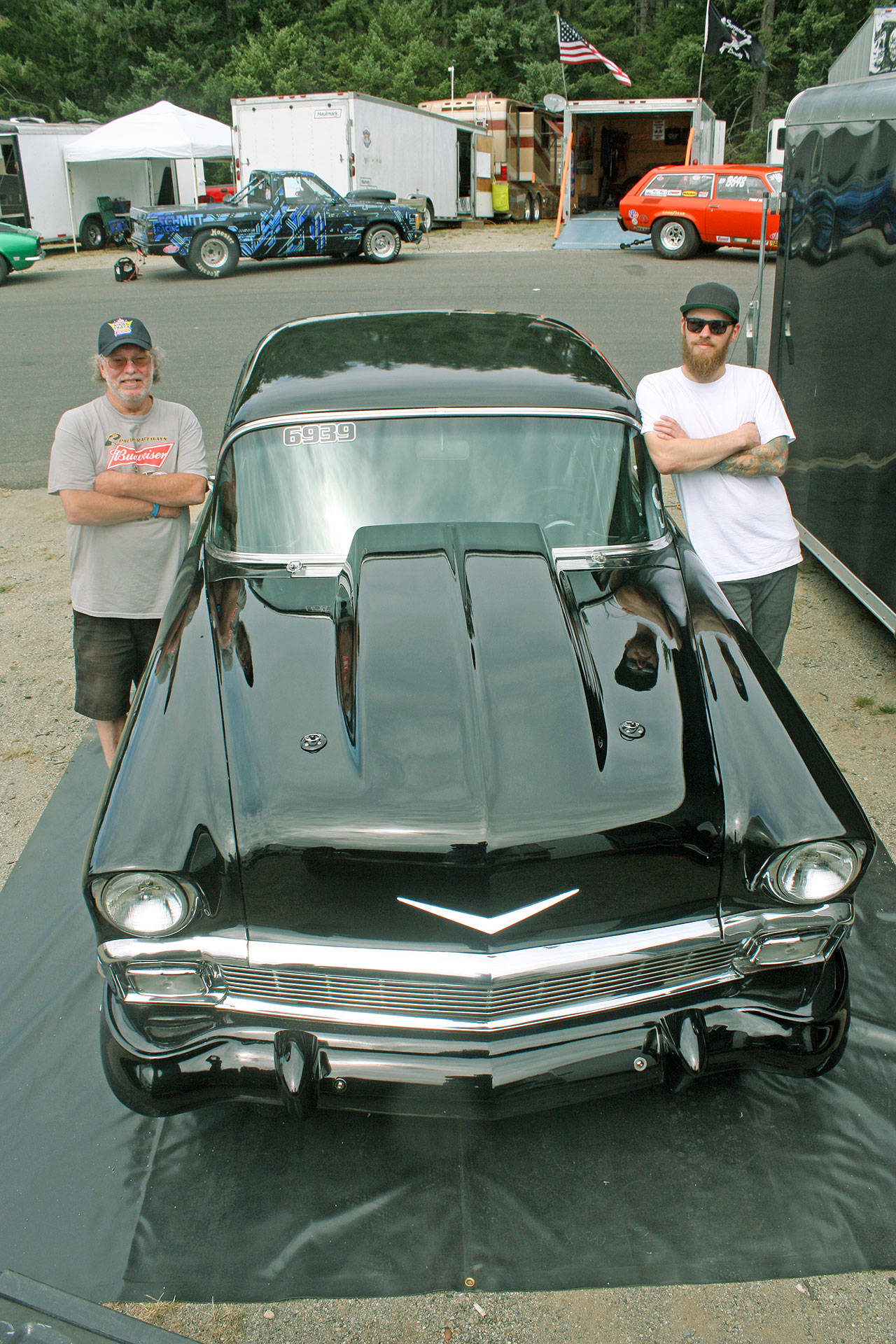 With the help of his father, Stan, left, Brian McGinnis, right, has emerged as a champion driver on the local drag strip. MARK KLAAS, Kent Reporter