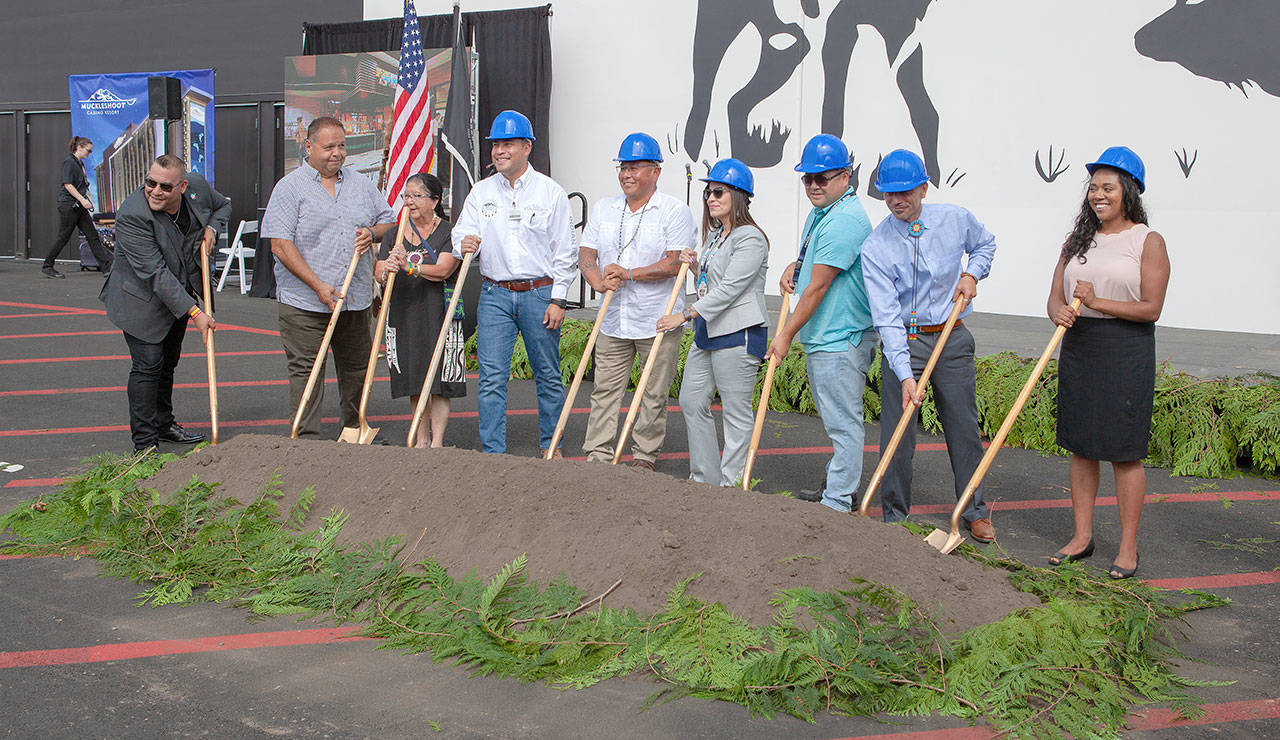 Members of the Muckleshoot Tribal Council participate in a dirt toss during the Sept. 5 groundbreaking of the luxury hotel tower at the casino. ROBERT WHALE, Auburn Reporter