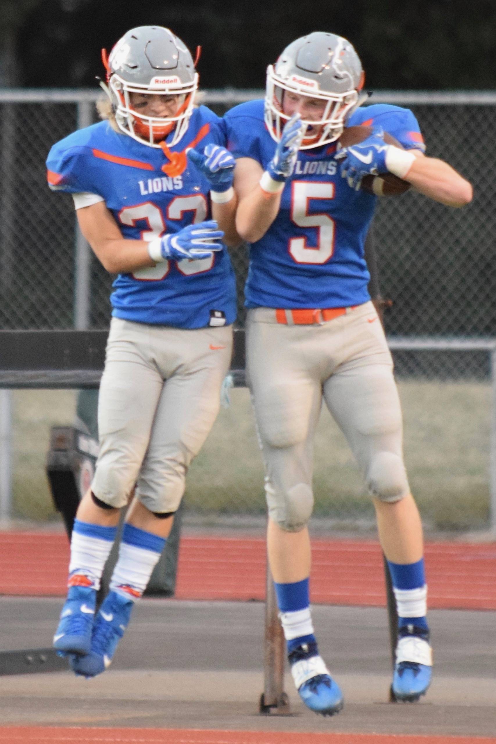 Auburn Mountainview’s Cooper White, left, and Teagin Child celebrate after Child scored on a 64-yard catch and run off a Kayde Bodine pass in the first quarter Thursday. RACHEL CIAMPI, Auburn Reporter