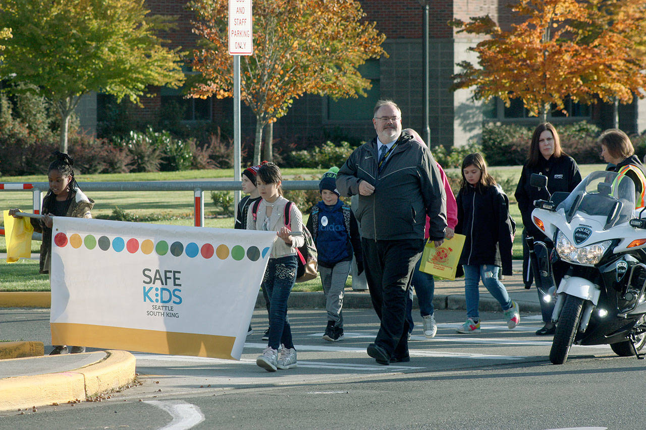 Auburn School District Superintendent Alan Spicciati joins Washington Elementary School students for an early morning walk along East Main Street to class Wednesday – International Walk to School Day. MARK KLAAS, Auburn Reporter