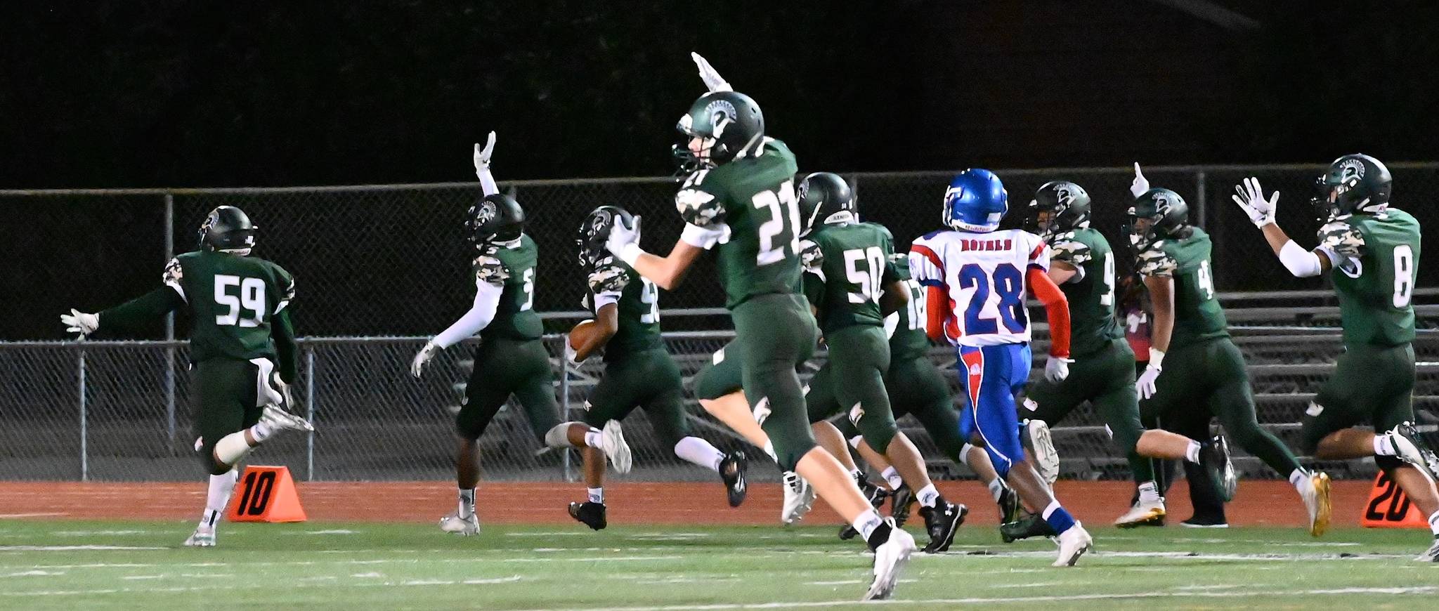 Auburn lineman Marquis Phillips returns a fumble 38 yards for a touchdown during the Trojans’ 47-6 romp over Kent-Meridian on Thursday night at Auburn Memorial Stadium. RACHEL CIAMPI, Auburn Reporter