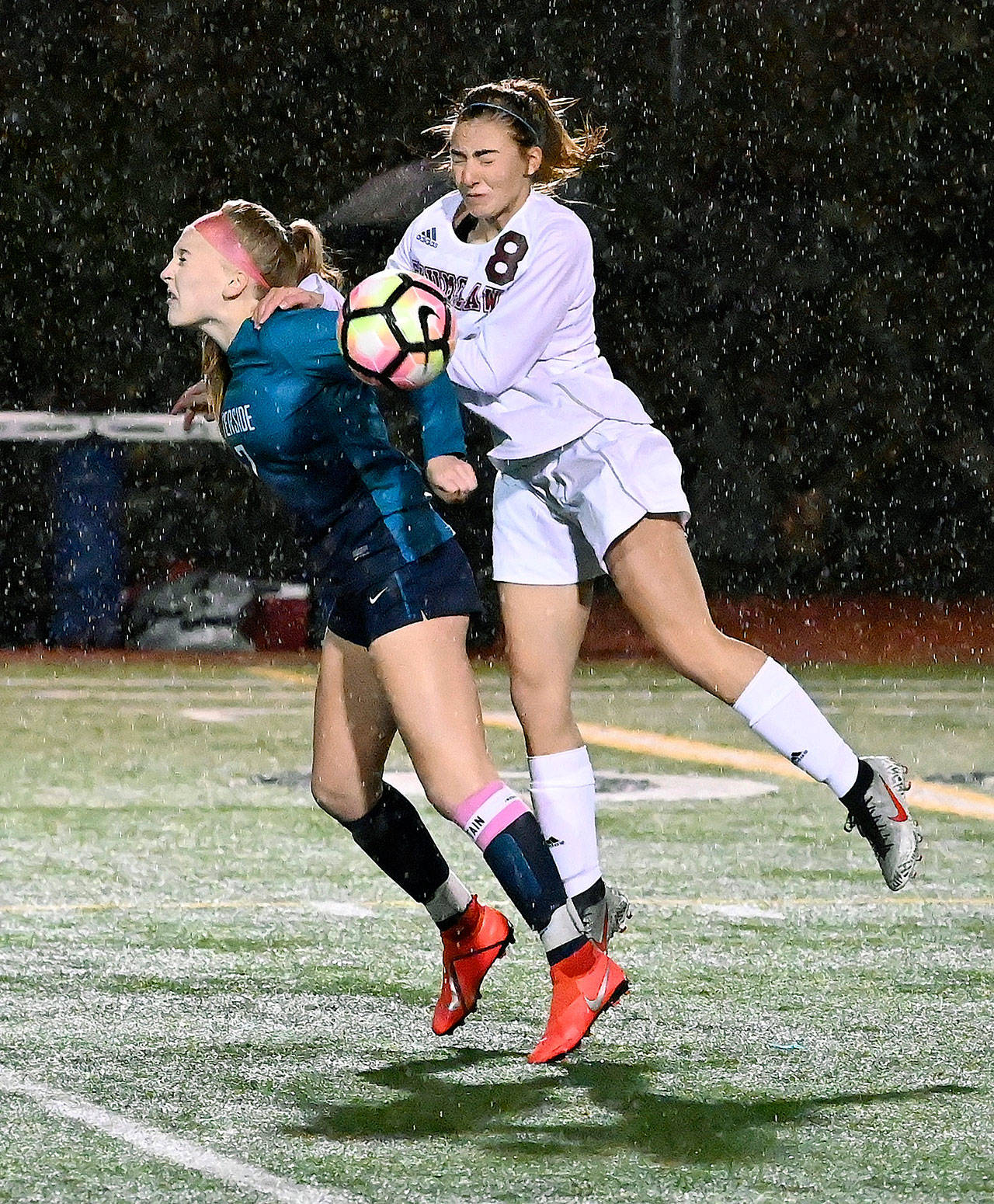 Auburn Riverside’s Kayla Rydberg, left, and Enumclaw’s Nicole Huff vie for the ball during a wet, gusty first half of their NPSL Olympic Division soccer match Thursday night at Auburn Riverside High School. RACHEL CIAMPI, Auburn Reporter