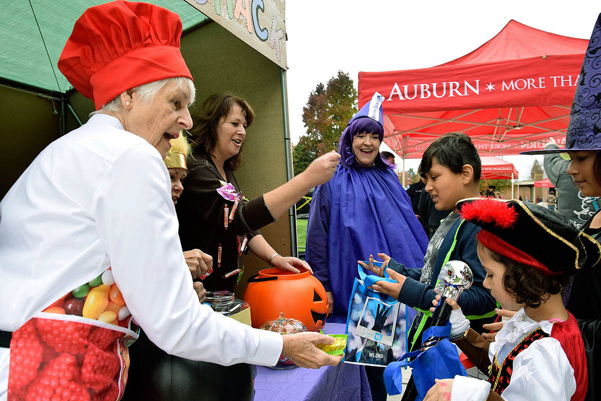 Auburn Police volunteers give out candy to trick-or-treaters at their Sugar Shack during last year’s Halloween Harvest Festival. RACHEL CIAMPI, Auburn Reporter