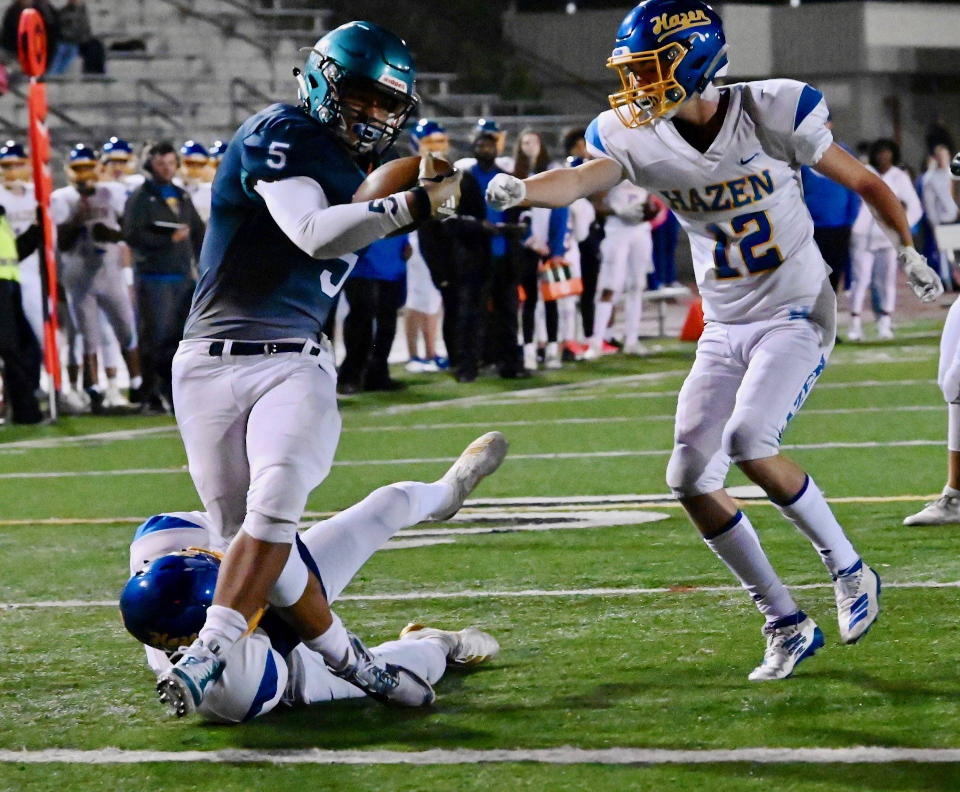 Auburn Riverside running back Javon Forward breaks one tackle as Hazen’s Charles Castaneda reaches to make a stop during first-half action Friday night at Auburn Memorial Stadium. Forward scored on the play in the Ravens’ 62-0 romp. RACHEL CIAMPI, Auburn Reporter