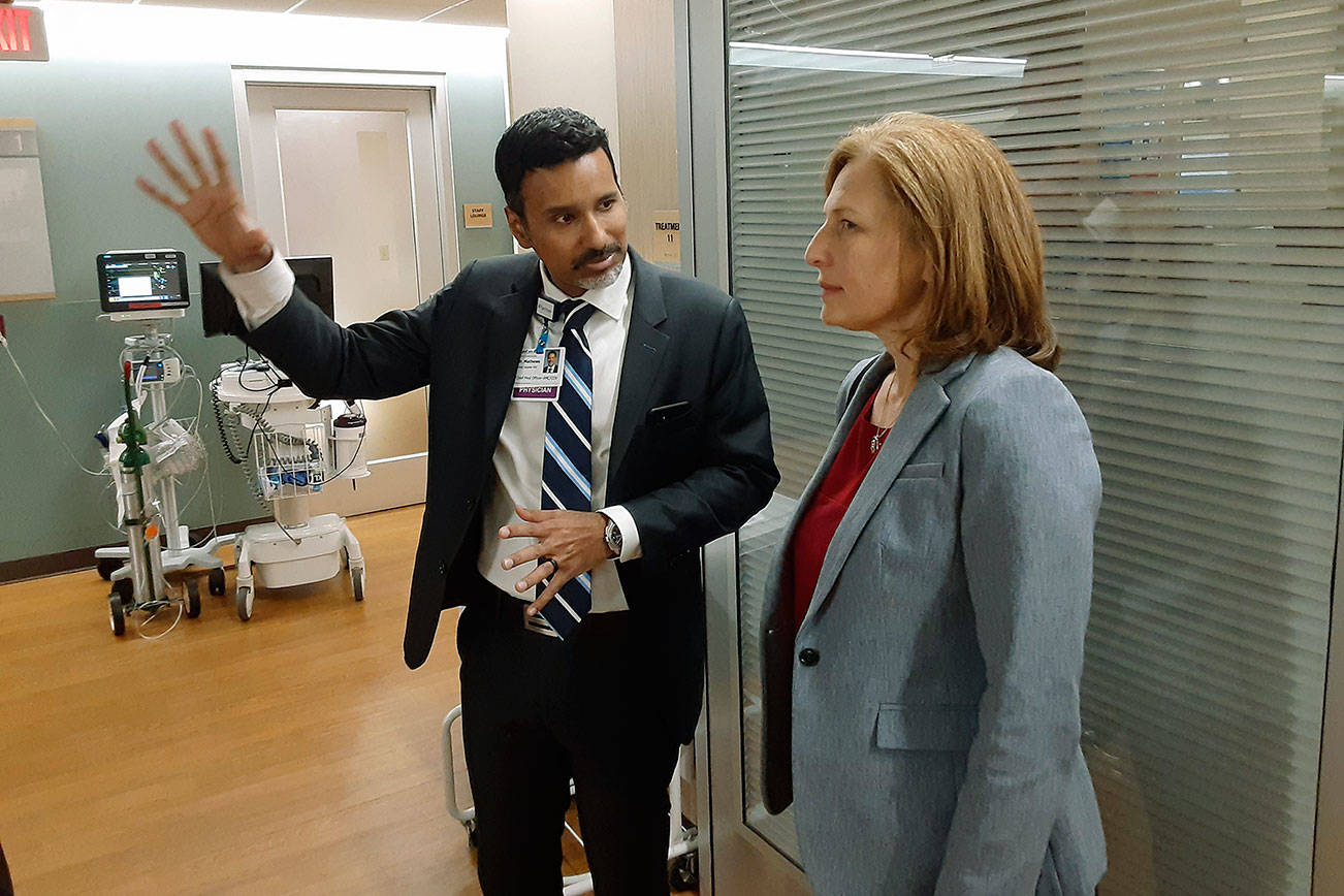 U.S. Eighth Congressional District Rep. Kim Schrier listens closely as Dr. Arun Matthews explains advances MultiCare Auburn Medical Center has made in recent years. ROBERT WHALE, Auburn Reporter