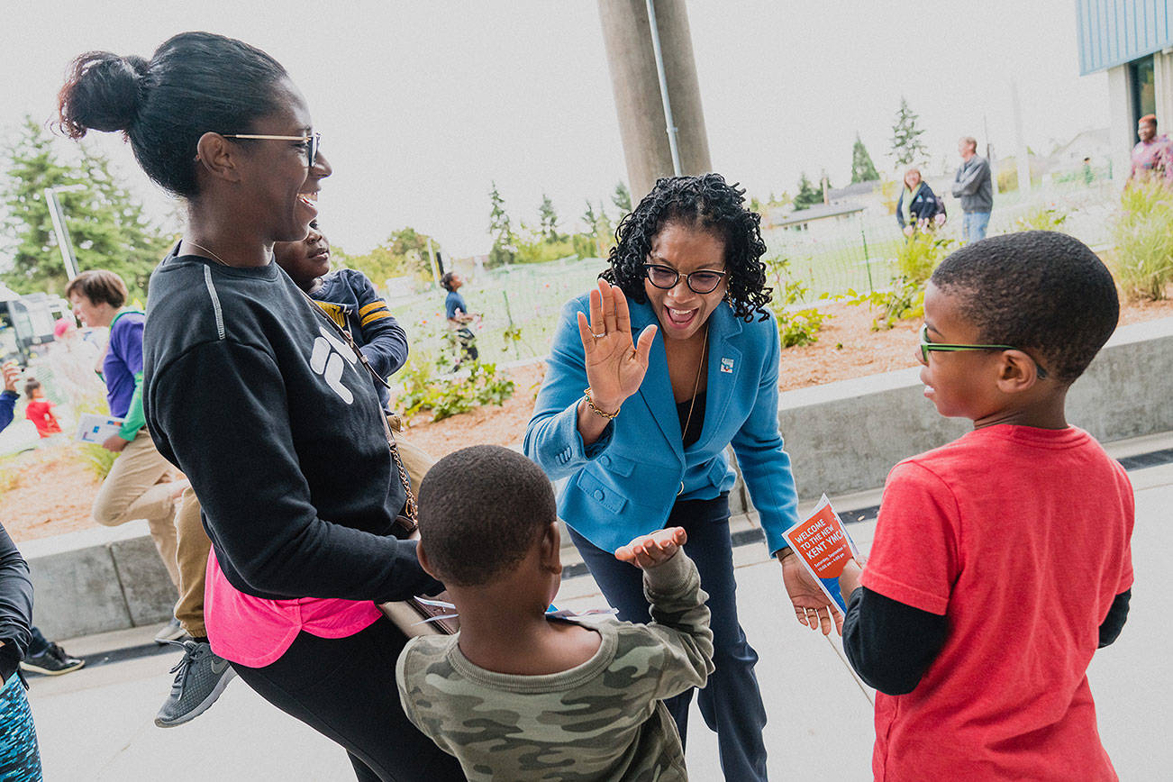 Loria Yeadon, CEO and president of the YMCA of Greater Seattle, high-fives a child who was with his family during the mid-September grand opening of the new YMCA on Kent’s East Hill. COURTESY PHOTO, Brandon Patoc (patoc.co)