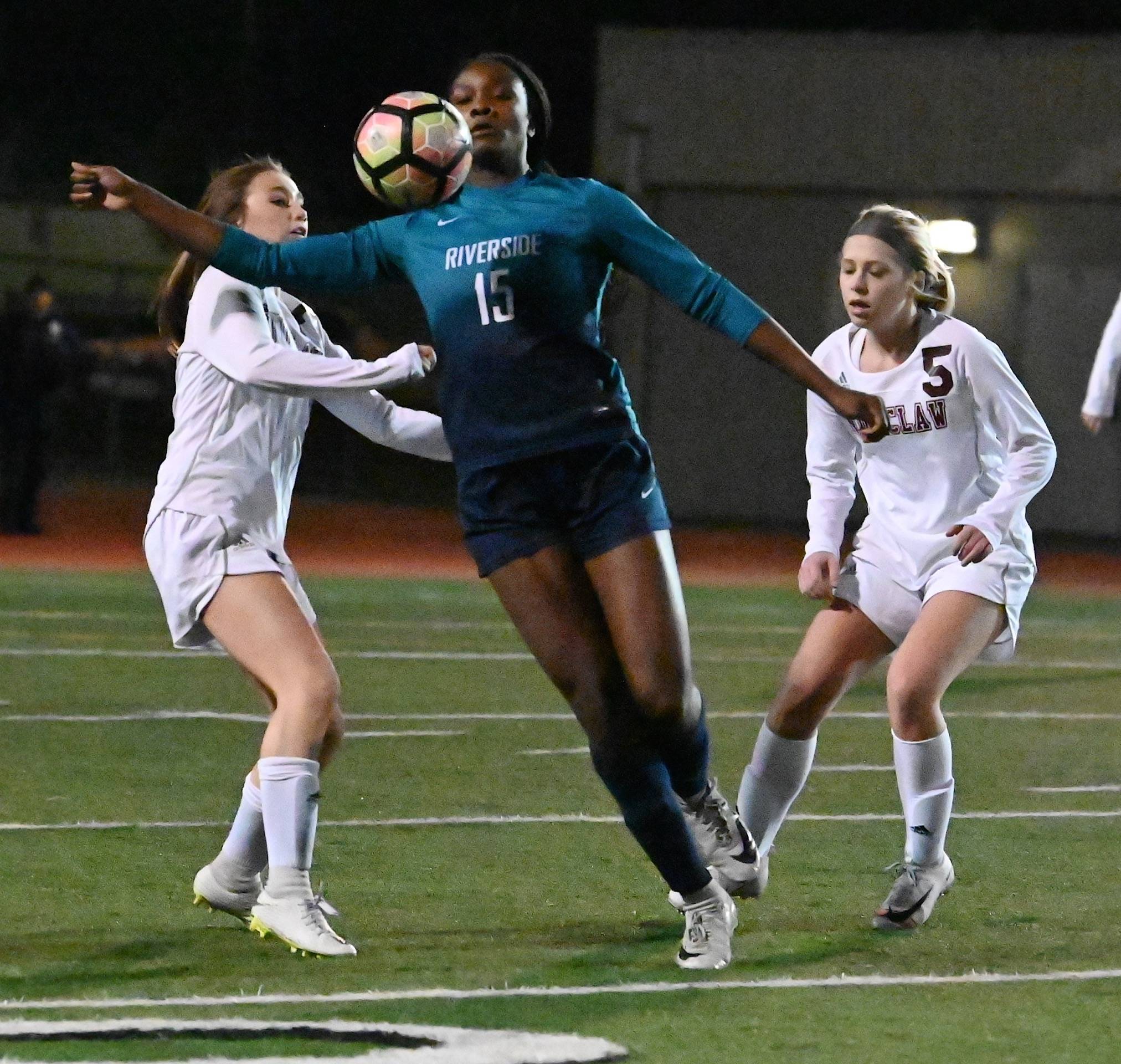 Auburn Riverside’s Stephanie Igwala battles for possession of the ball between Enumclaw defenders during 4A state playoff action Wednesday night. RACHEL CIAMPI, Auburn Reporter