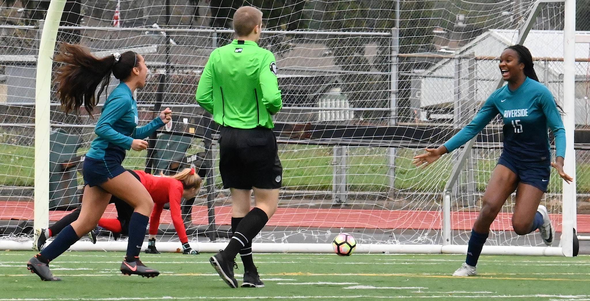 Auburn Riverside’s Samiah Shell, left, and Stephanie Igwala react after Shell scores early in the second half against Olympia during a 4A state quarterfinal playoff at Auburn Memorial Stadium. RACHEL CIAMPI, Auburn Reporter