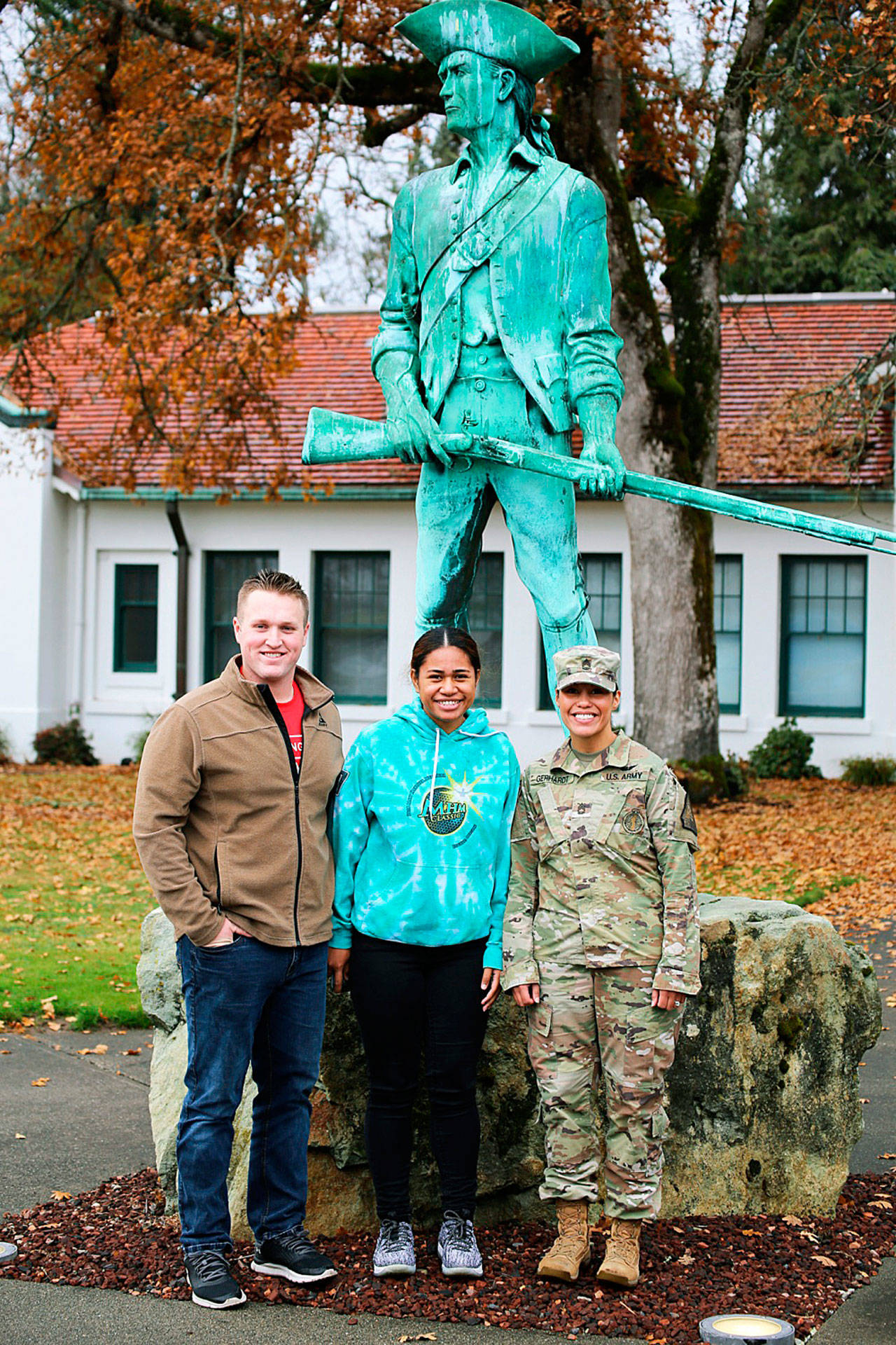 From left, Private 2nd Class Hunter White, PV2 April Talaiga and Staff Sgt. Marilyn Gerhardt stand with the Minuteman statue at Camp Murray on Nov. 17. The couple joined the Guard together on Oct. 30. COURTESY PHOTO, U.S. National Guard, Joseph Siemandel