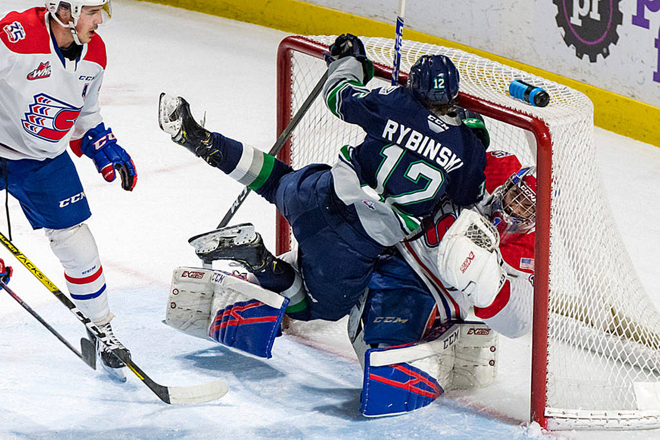 Thunderbirds center Henrik Rybinski collides with Chiefs goalie Campbell Arnold during WHL play Tuesday night. COURTESY PHOTO, Brian Liesse, T-Birds