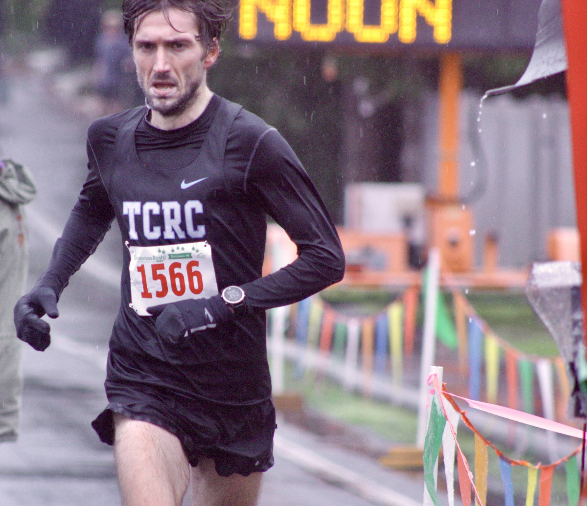 Tacoma’s Greg Leak reaches the finish line to capture the 10,000-kilometer win at the 36th Christmas Rush Fun Run And Walk. Leak’s winning time of 29 minutes, 57.1 seconds was the first sub-30 time in the Kent run in 27 years. MARK KLAAS, Kent Reporter