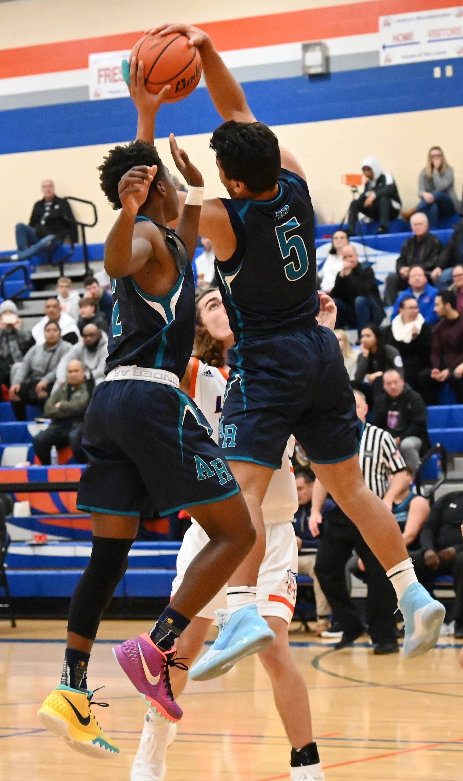 Auburn Riverside’s Javon Forward (5) and Kevin Griffin reach for a rebound against Auburn Mountainview on Friday night. RACHEL CIAMPI, Auburn Reporter