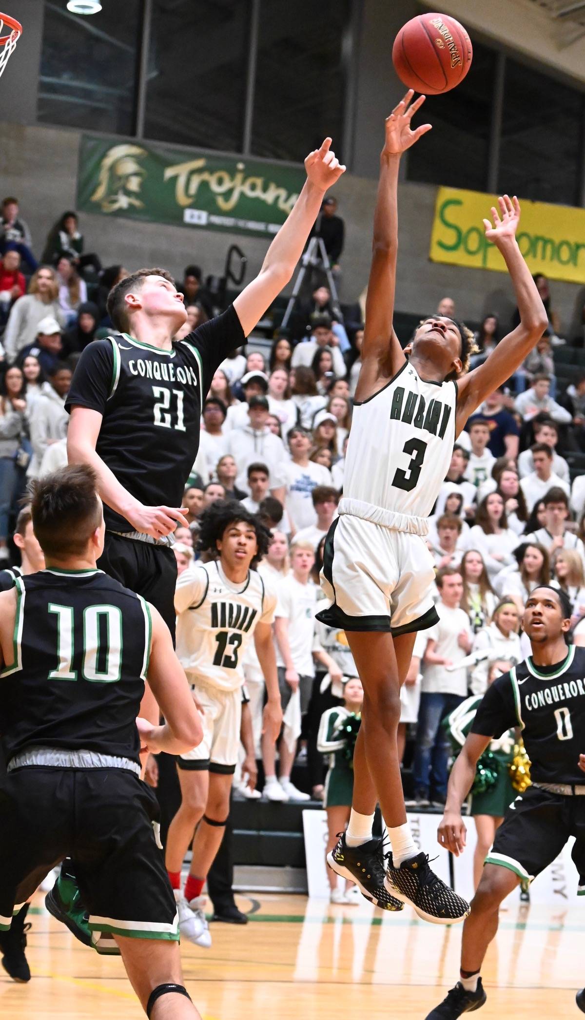 Auburn’s Amar Rivers and Kentwood’s Logan Stempniak reach for a rebound during play Friday night. RACHEL CIAMPI, Auburn Reporter