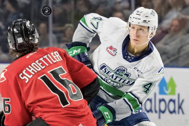 The Thunderbirds’ Lucas Ciona and the Cougars’ Ryan Schoettler fight for the puck during WHL play Sunday. COURTESY PHOTO, Brian Liesse, T-Birds