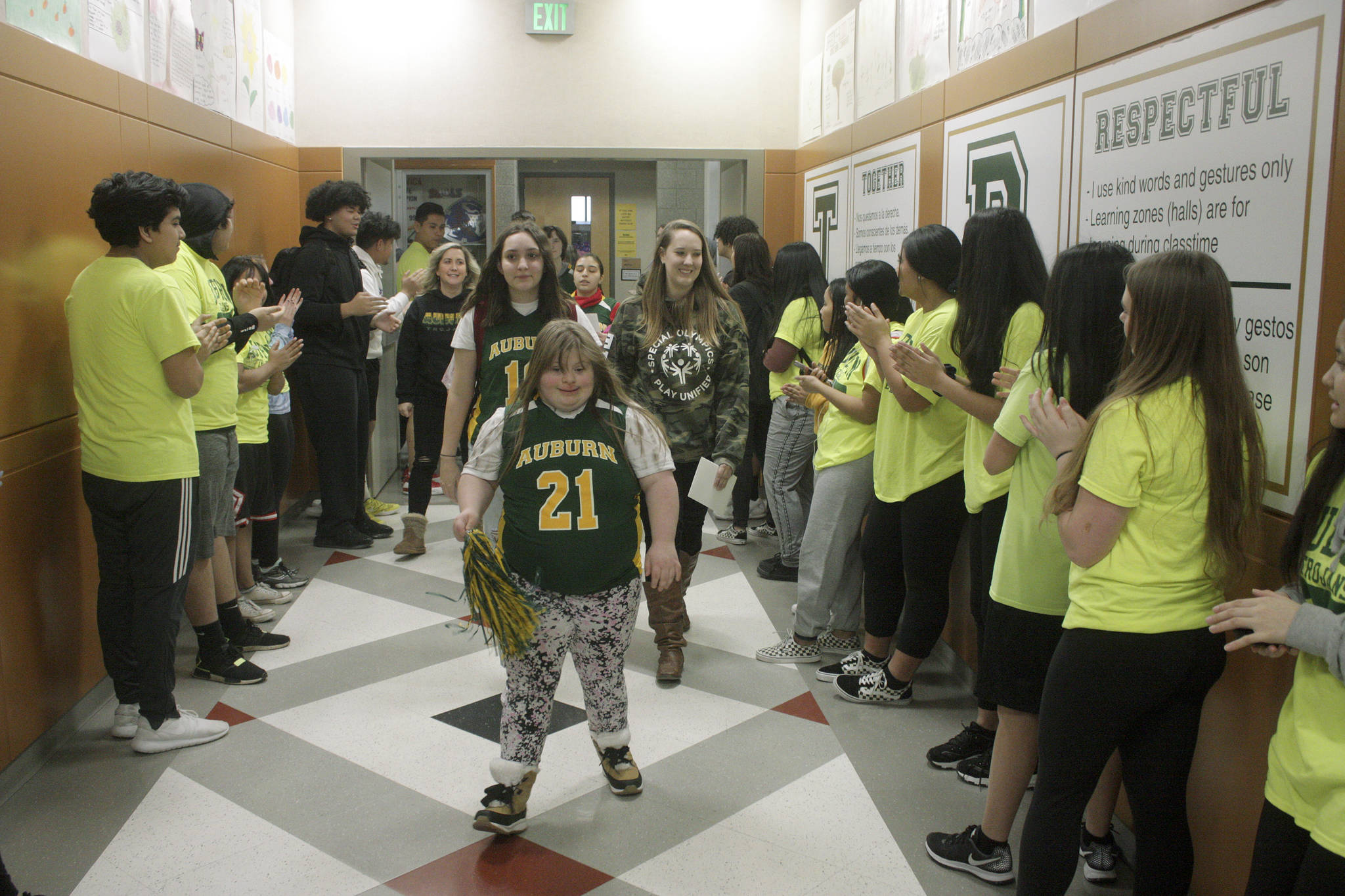 Lizzy Souers leads her teammates through the halls of Auburn High School en route to the gymnasium during a Walk of Champions for the Auburn Unified Special Olympics basketball team Tuesday. MARK KLAAS, Auburn Reporter