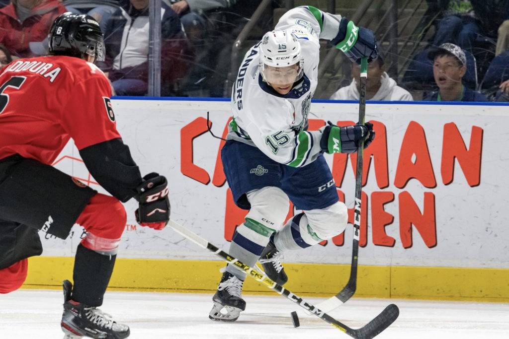 The Thunderbirds’ Mekai Sanders maneuvers the puck up the ice as the Cougars’ Majid Kaddoura defends during WHL play Sunday at the accesso ShoWare Center. COURTESY PHOTO, Brian Liesse, T-Birds