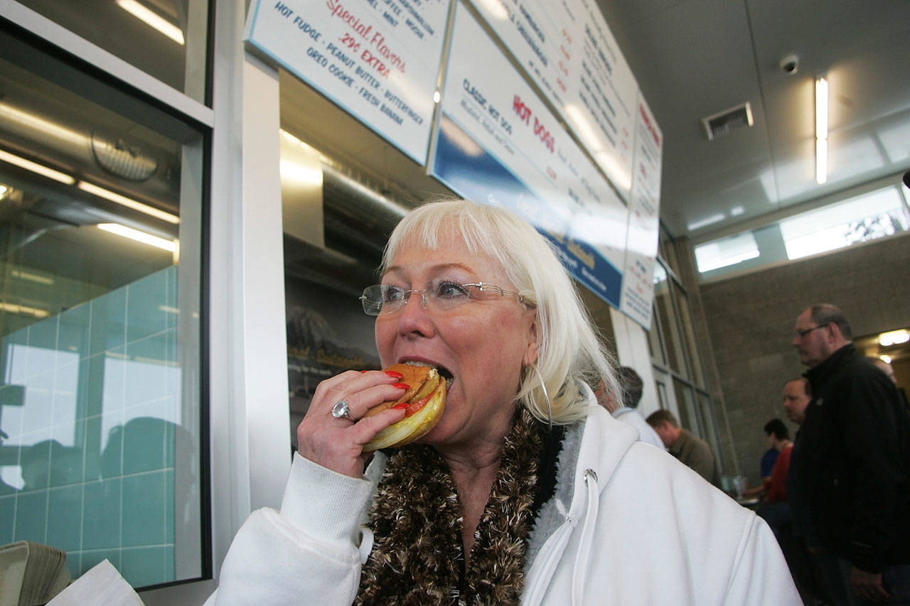 Kelly Rotroff, of Auburn, enjoys the first burger as the first customer at the Pick-Quick Drive In No. 2 on March 8, 2011. REPORTER FILE PHOTO