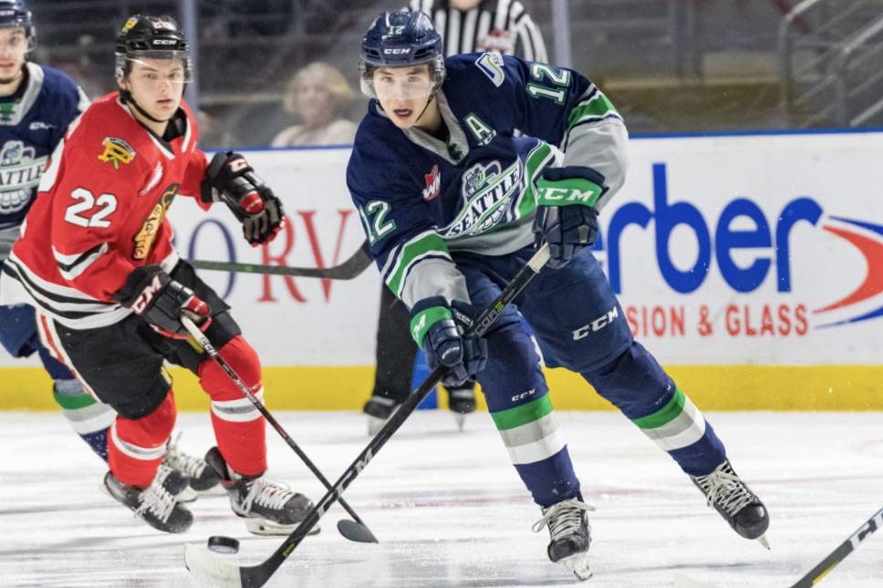 The Thunderbirds’ Henrik Rybinski pushes the puck up the ice with the Winterhawks’ Jaydon Dureau in pursuit. COURTESY PHOTO, Brian Liesse, T-Birds