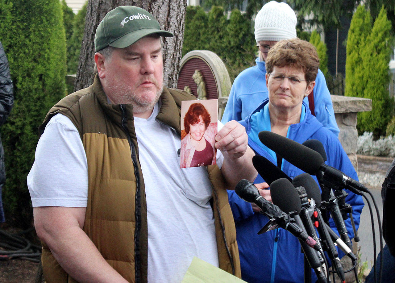 Mike Weatherill holds up a picture of his mother, Louise, at a March 5 press conference. Louise, who was a resident of Life Care, died yesterday. It is unknown whether she died from coronavirus. Blake Peterson/staff photo