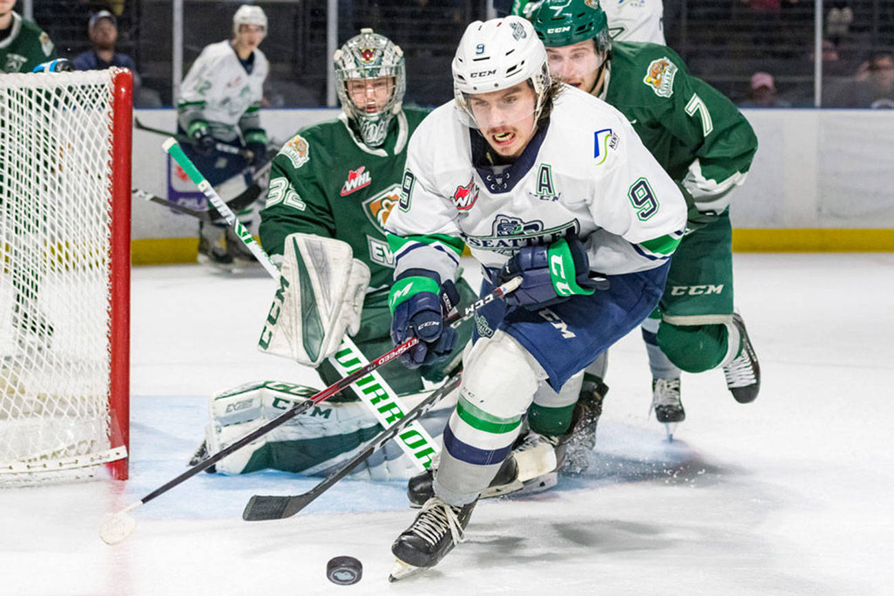 1The Thunderbirds’ Keltie Jeri-Leon handles the puck in front of the Silvertips’ Ethan Regnier and goalie Dustin Wolf during WHL action Sunday at the accesso ShoWare Center. COURTESY PHOTO, Brian Liesse, T-Birds