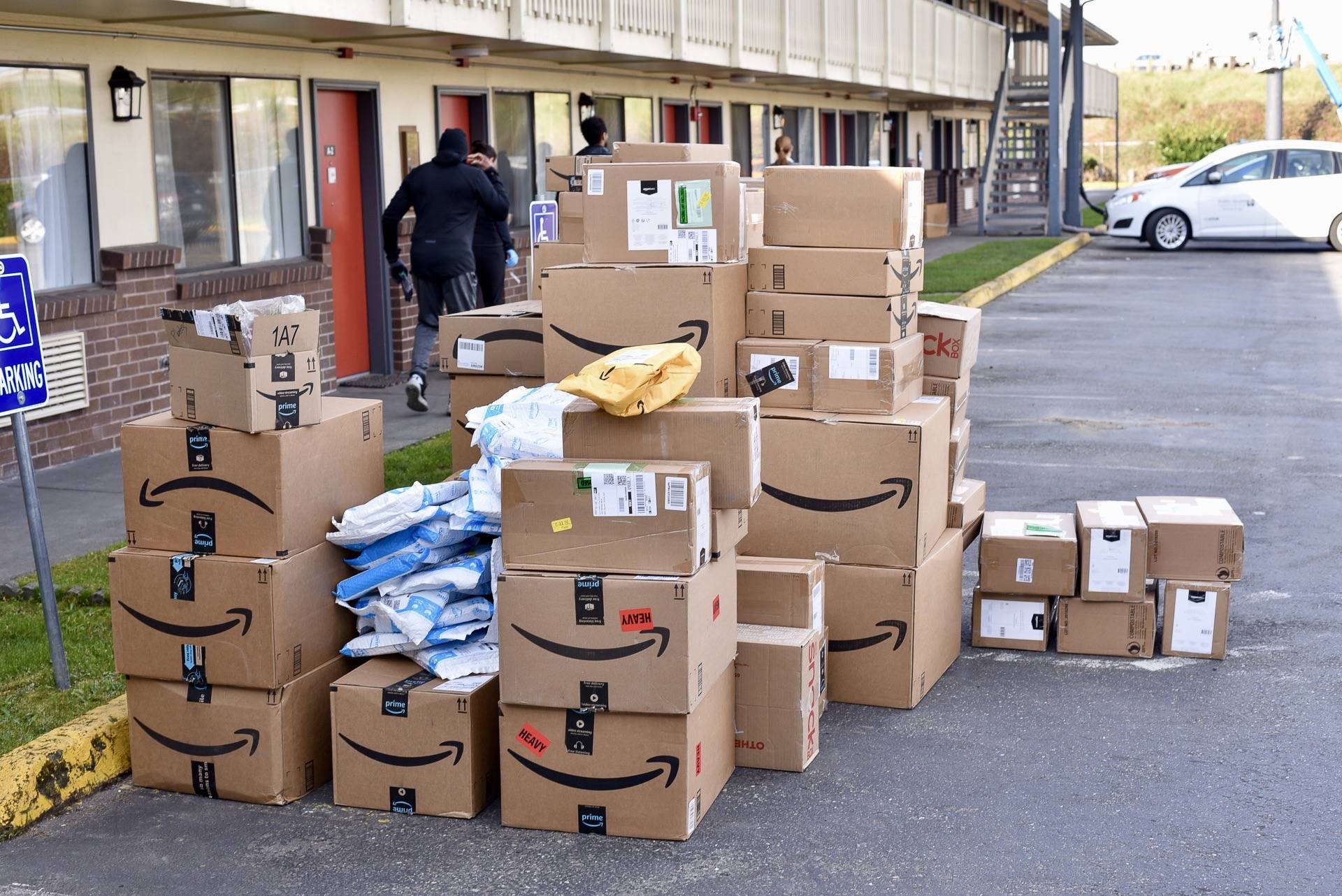 Amazon workers on Tuesday deliver donated supplies to a King County owned and former motel in Kent, now a temporary housing facility for patients in quarantine, isolation and recovery due to COVID-19. COURTESY PHOTO, King County