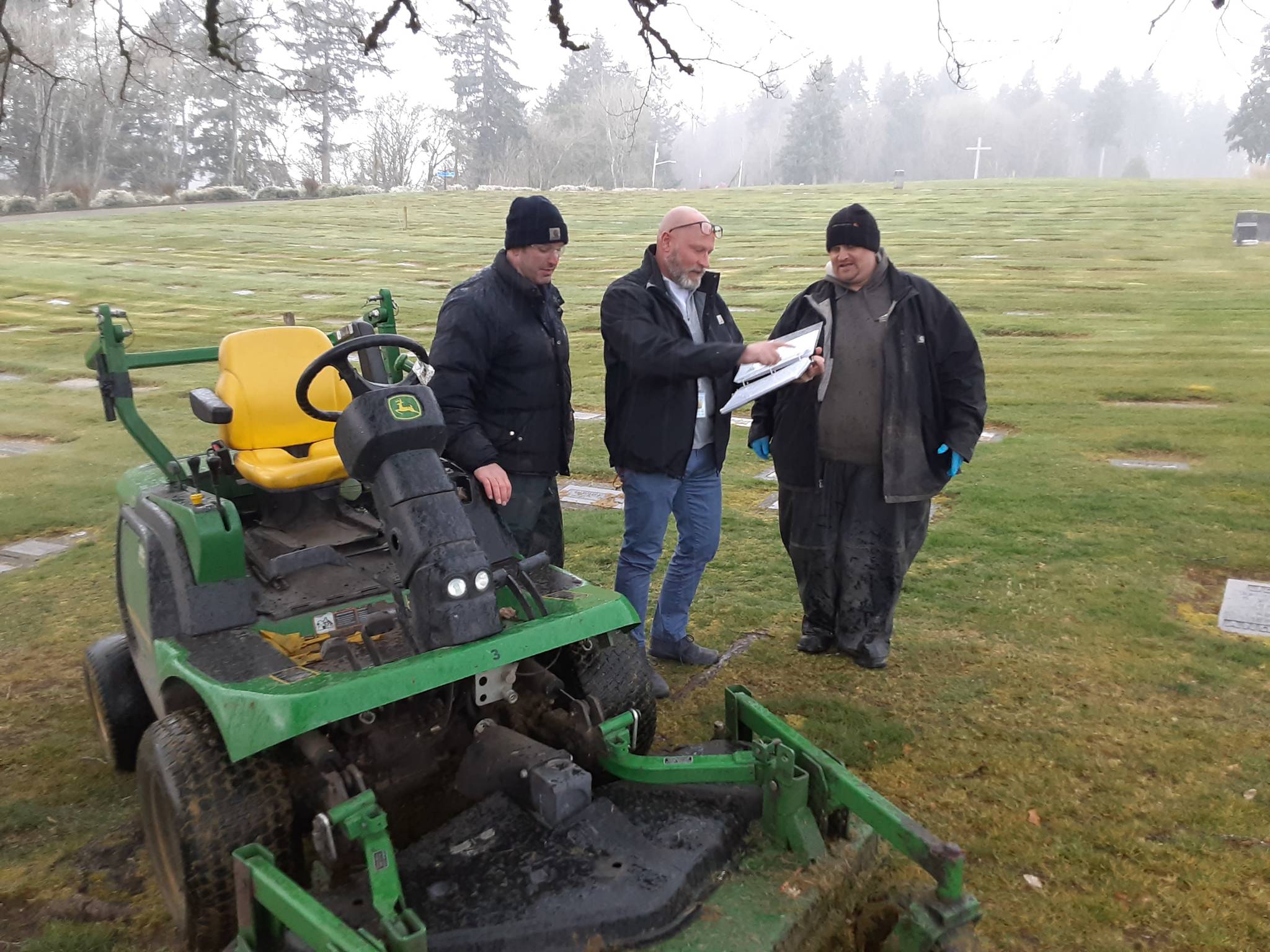 Auburn Mountain View Cemetery Manager Craig Hudson, center, confers with maintenance workers David Partridge, left, and Zach Hopper in March 2020. Sound Publishing file photo