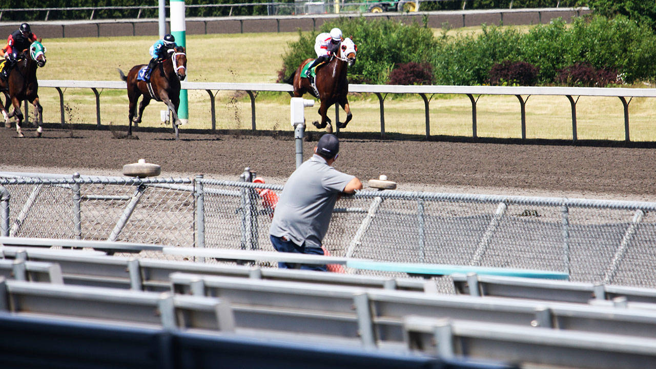 One man stands along the rail during opening day June 24 at Emerald Downs in Auburn. STEVE HUNTER, Kent Reporter