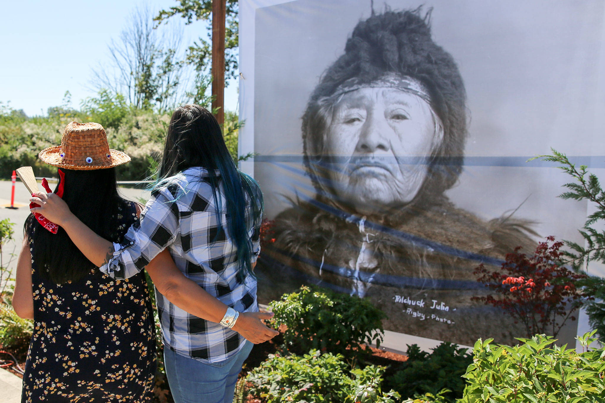 Guests gather to view a photo of Pilchuck Julia during the naming ceremony of the Snohomish River boat landing named for her in August, 2019. (Kevin Clark / Herald file photo)