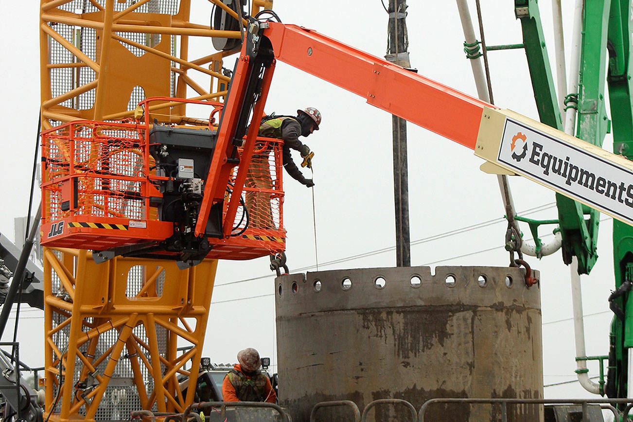 A construction worker measures a drill shaft during installation at the future Sound Transit Kent/Des Moines light rail site on Oct. 7. Olivia Sullivan/the Mirror