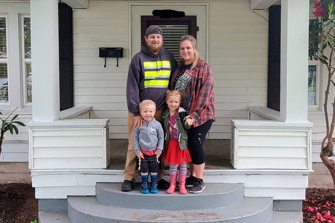 Luke, Sarah, Remi, and Ryker Lenihan in front of their new home. Contributed photo
