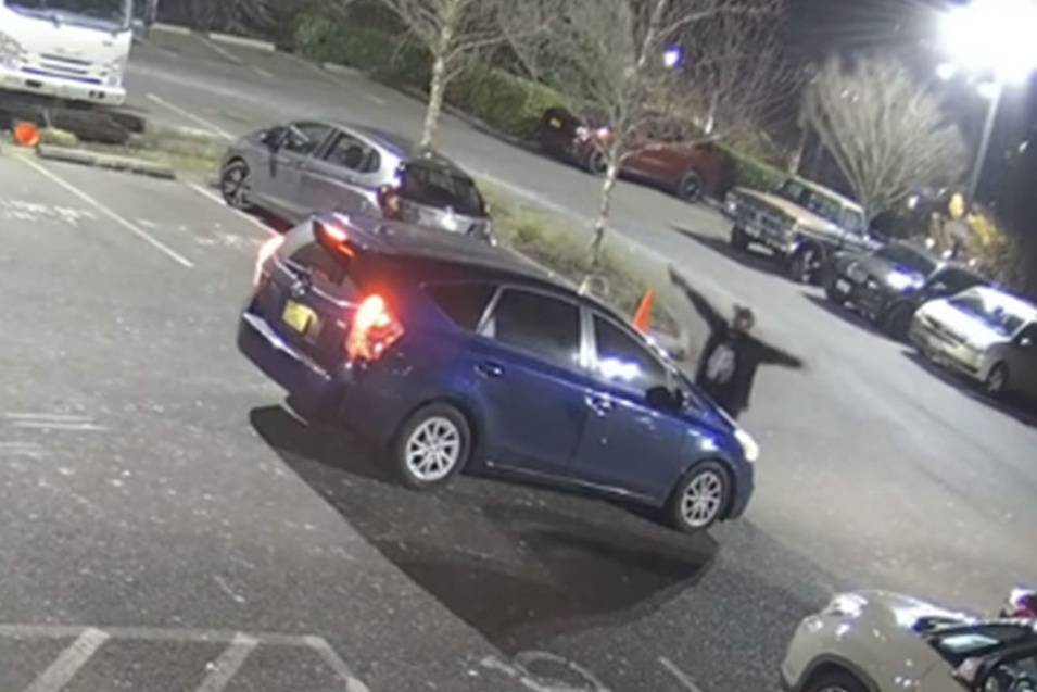 A screenshot from private surveillance footage provided by the Seattle Police Department shows a suspect engaging with the occupants of a vehicle on Feb. 9, 2021, in Seattle. The suspect shot the vehicle’s two occupants, one fatally, before he was killed by police. File photo