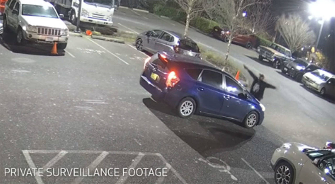 A screenshot from private surveillance footage provided by the Seattle Police Department shows a suspect engaging with the occupants of a vehicle on Feb. 9, 2021, in Seattle. The suspect shot the vehicle’s two occupants, one fatally, before he was killed by police. File photo