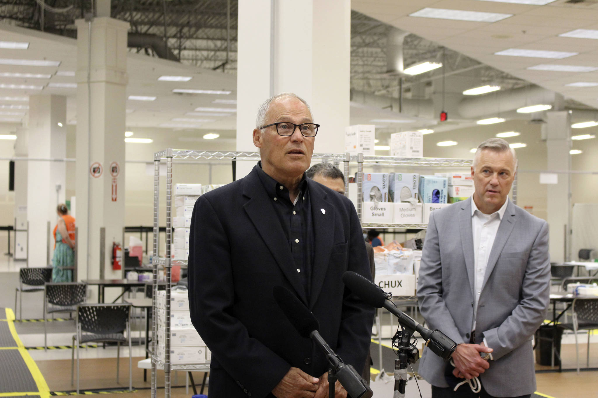 Gov. Jay Inslee (center) gives a speech on the importance of getting vaccinated and to spread awareness of the state's efforts to vaccinate all Washingtonians during his visit to the Auburn vaccine clinic on Tuesday, June 22, 2021. Photo by Henry Stewart-Wood/Auburn Reporter