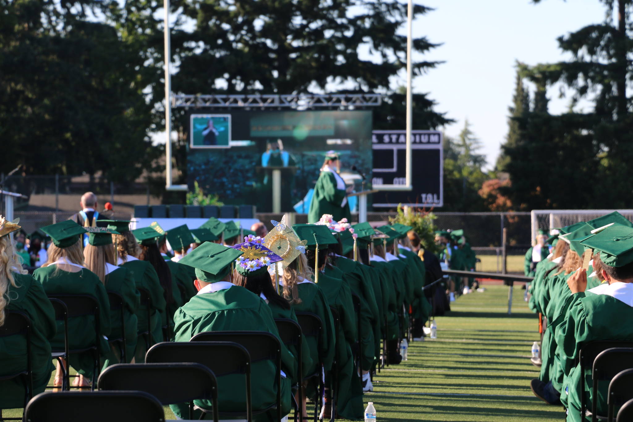 Auburn High School graduates-to-be listen as their class speaker addresses them during the 2021 graduation ceremony at Veterans Memorial Stadium. Courtesy photo.