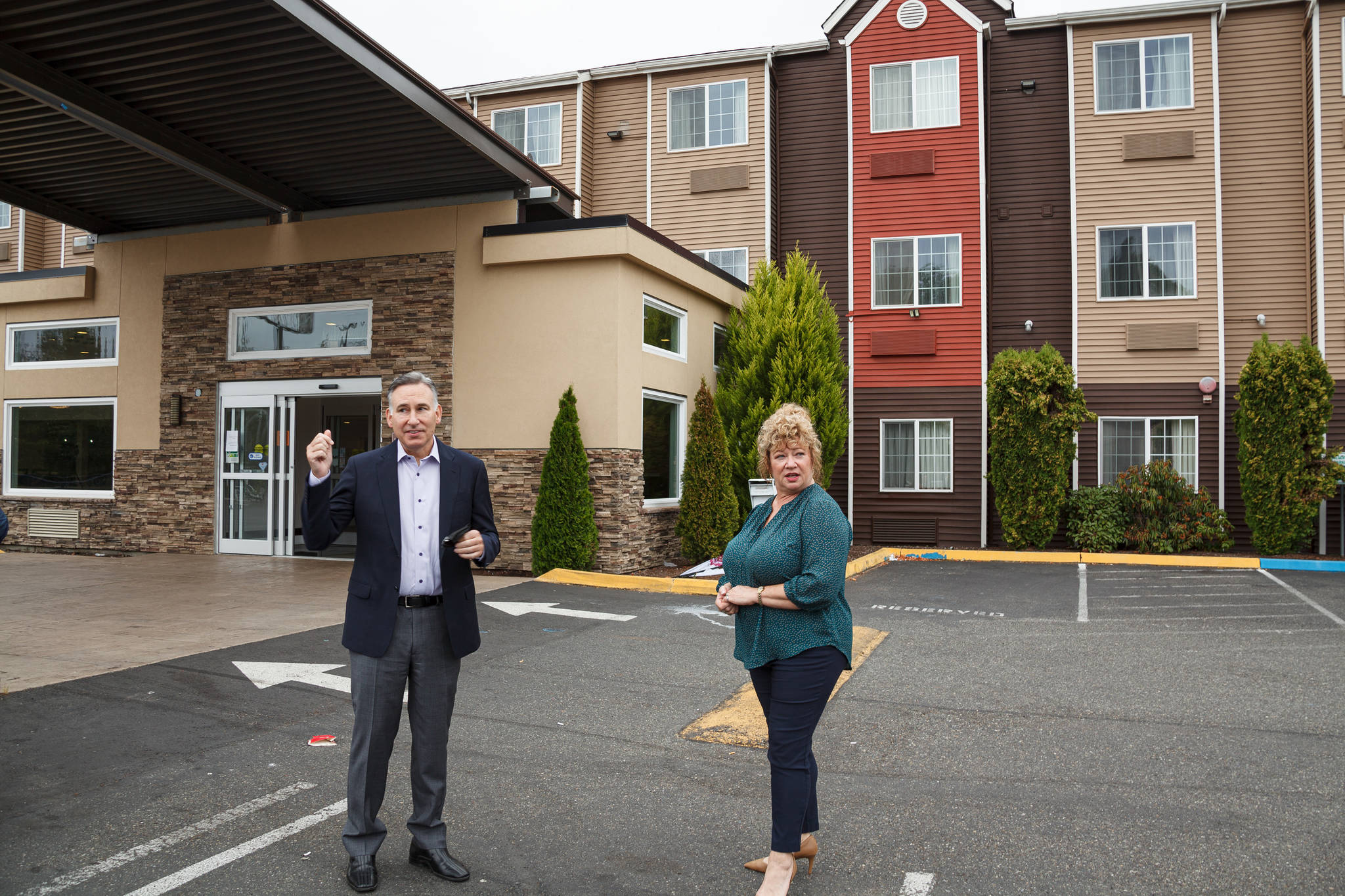King County Executive Dow Constantine and Auburn Mayor Nancy Backus stand in front of the Clarion Hotel in Auburn on Tuesday July 20. The hotel will be used to house approximately 100 people experiencing homelessness in the area as part of the county’s Health Through Housing program. Photo by Henry Stewart-Wood.