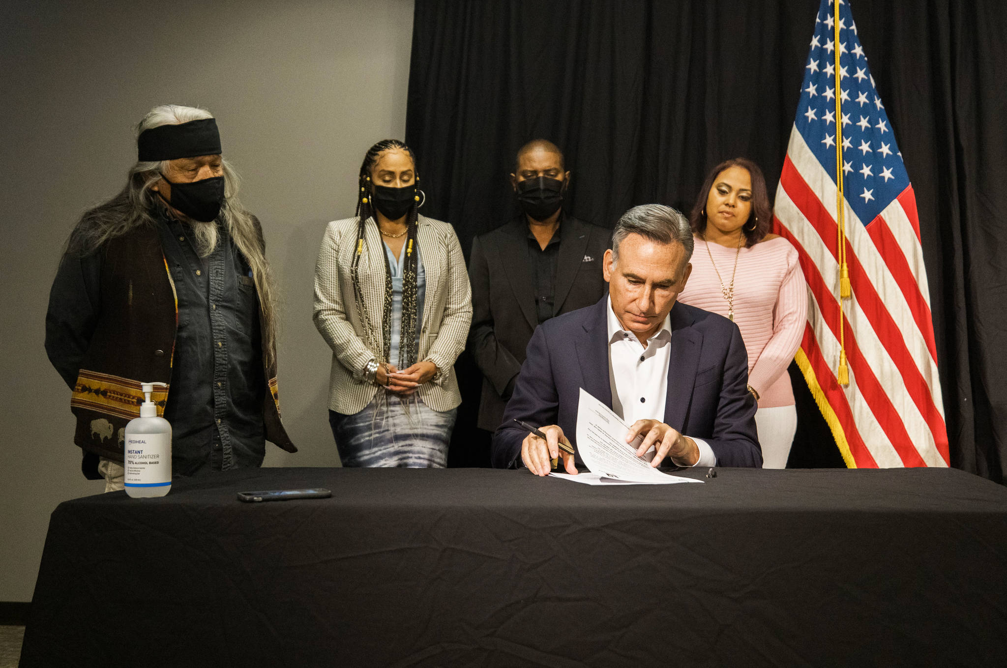King County Executive Dow Constantine signs an order July 28 to restart inquests into deaths that involved police officers. COURTESY PHOTO, King County