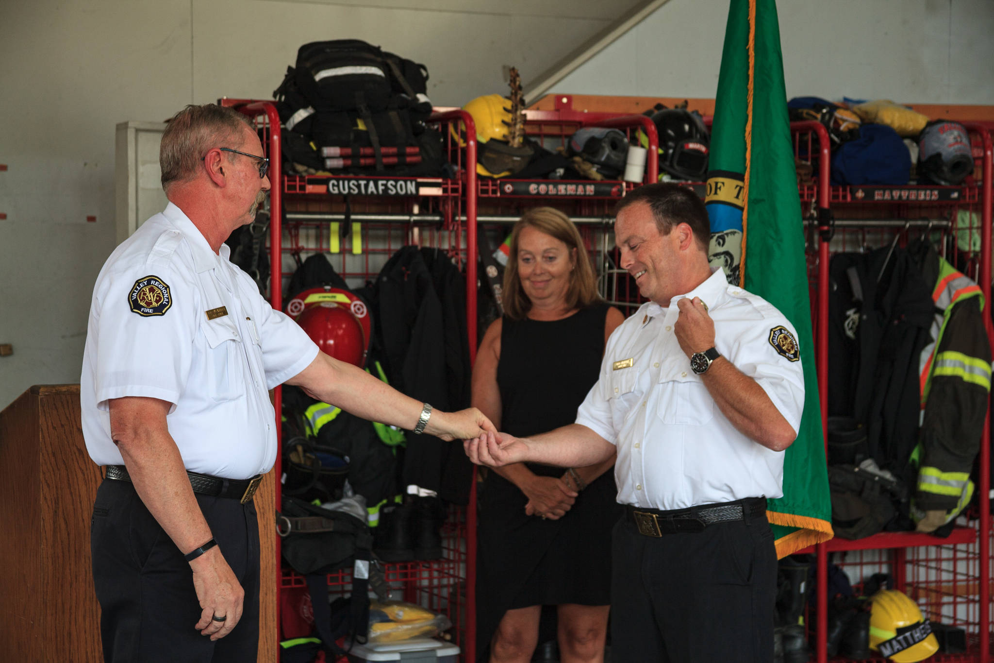 Chief Brent Swearingen hands new VRFA Chief Brad Thompson his badges during the change of command ceremony on Aug. 5. Photo by Henry Stewart-Wood/Auburn Reporter