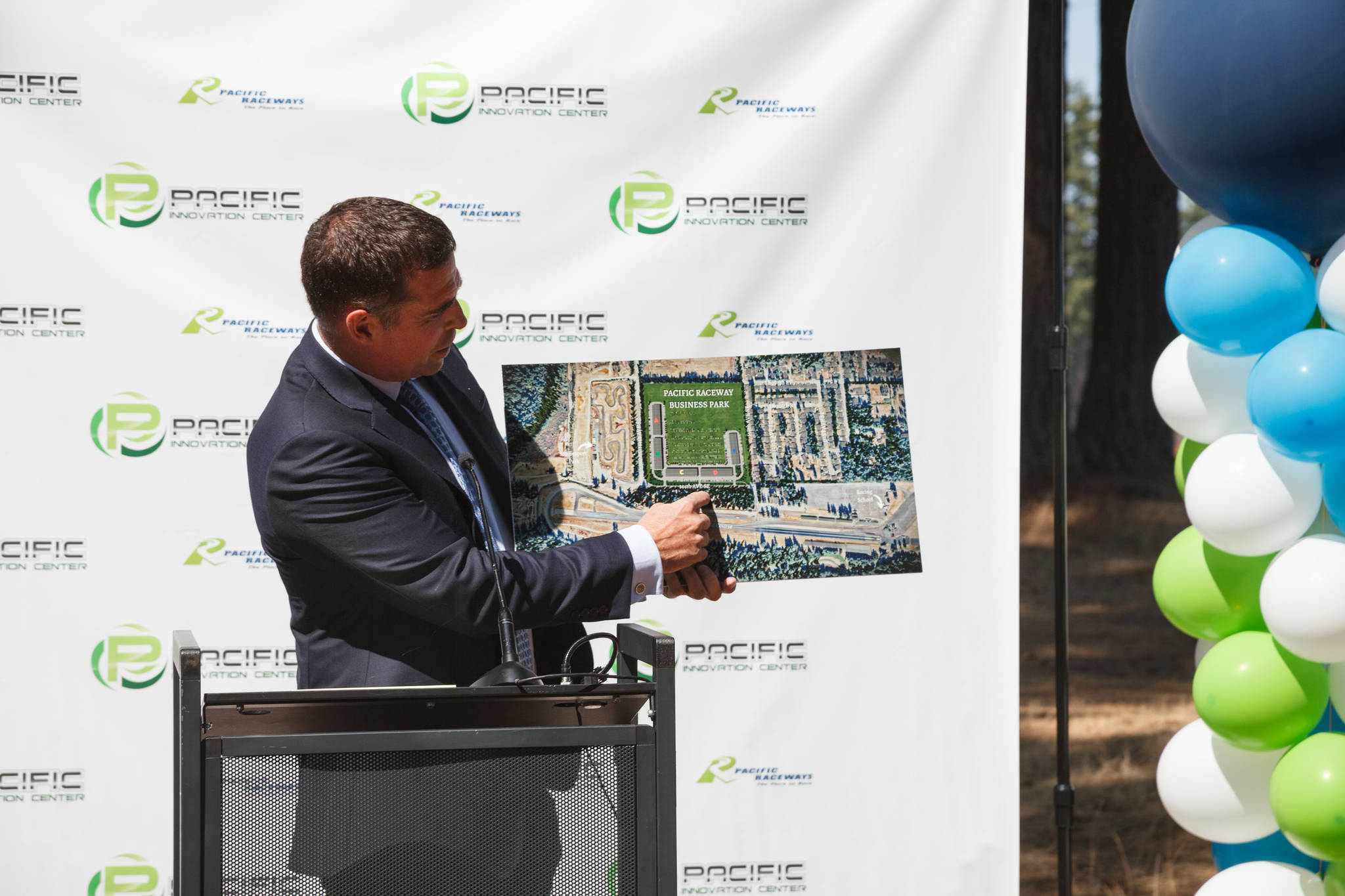 Jason Fiorito shows a rendering of the new buildings during Pacific Raceways groundbreaking event on Wednesday, Aug. 18, 2021. Photo by Henry Stewart-Wood/Sound Publishing