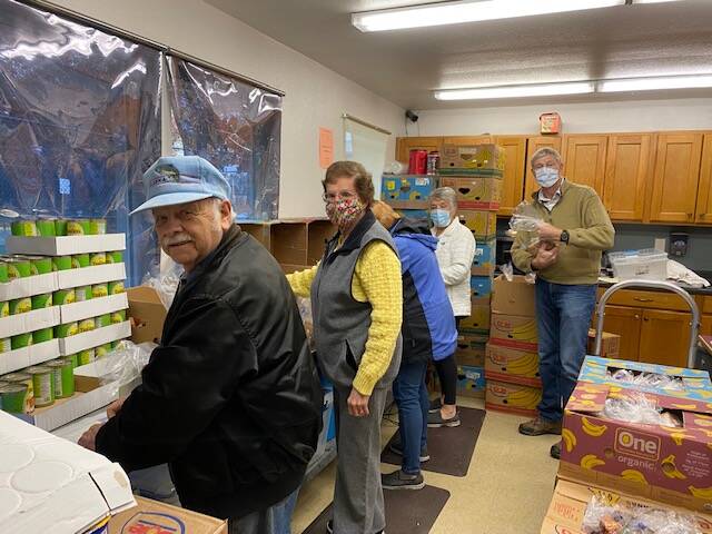 Lions Club members Allen Geiszler, Gloria Taylor, Kathy Johnson, Chris Harrington and Dan Harrington pack bags for the Auburn Food Bank’s Food to Go program. Courtesy photo, Debbie Christian.